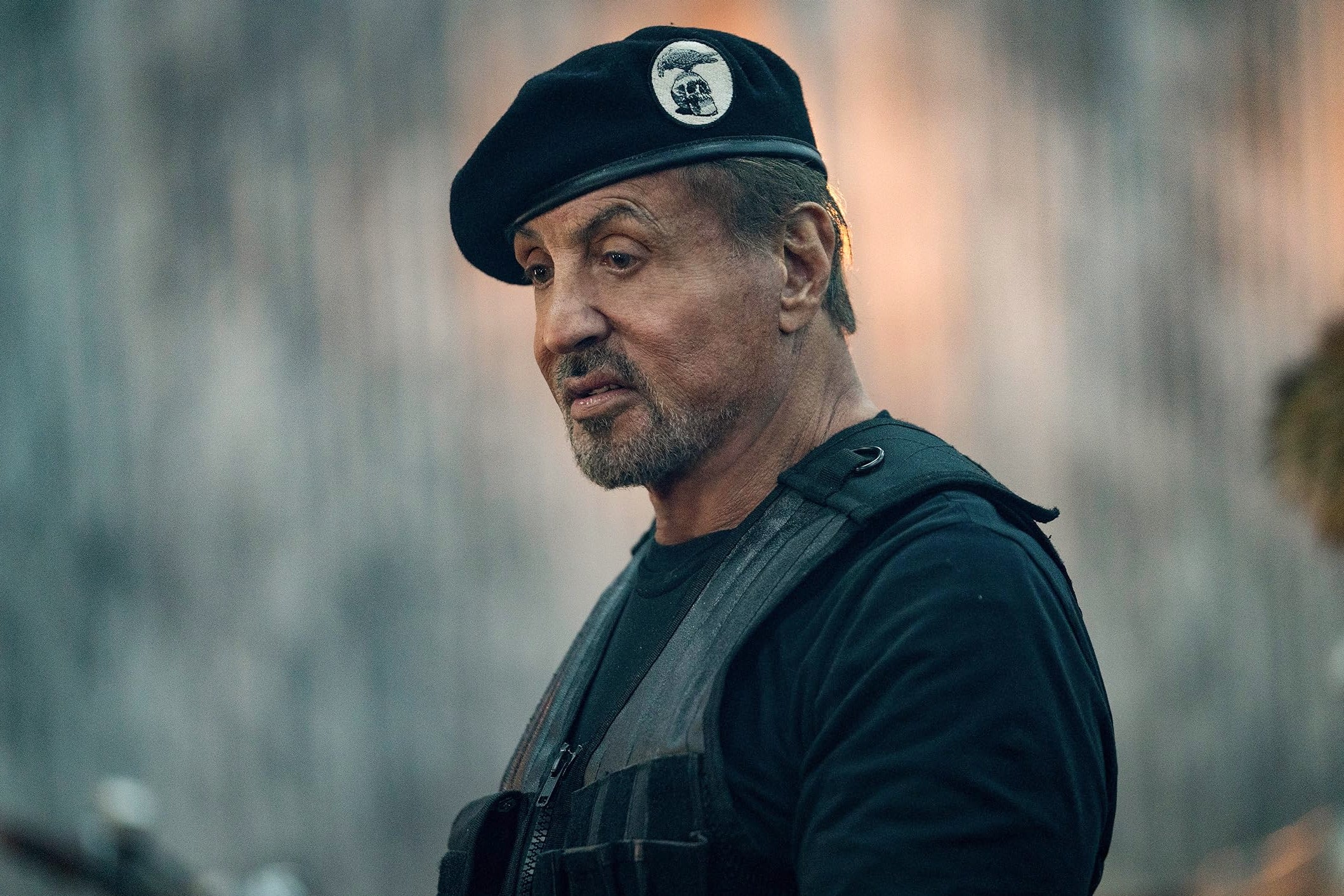 Sylvester Stallone wearing a beret in character in The Expendables. 