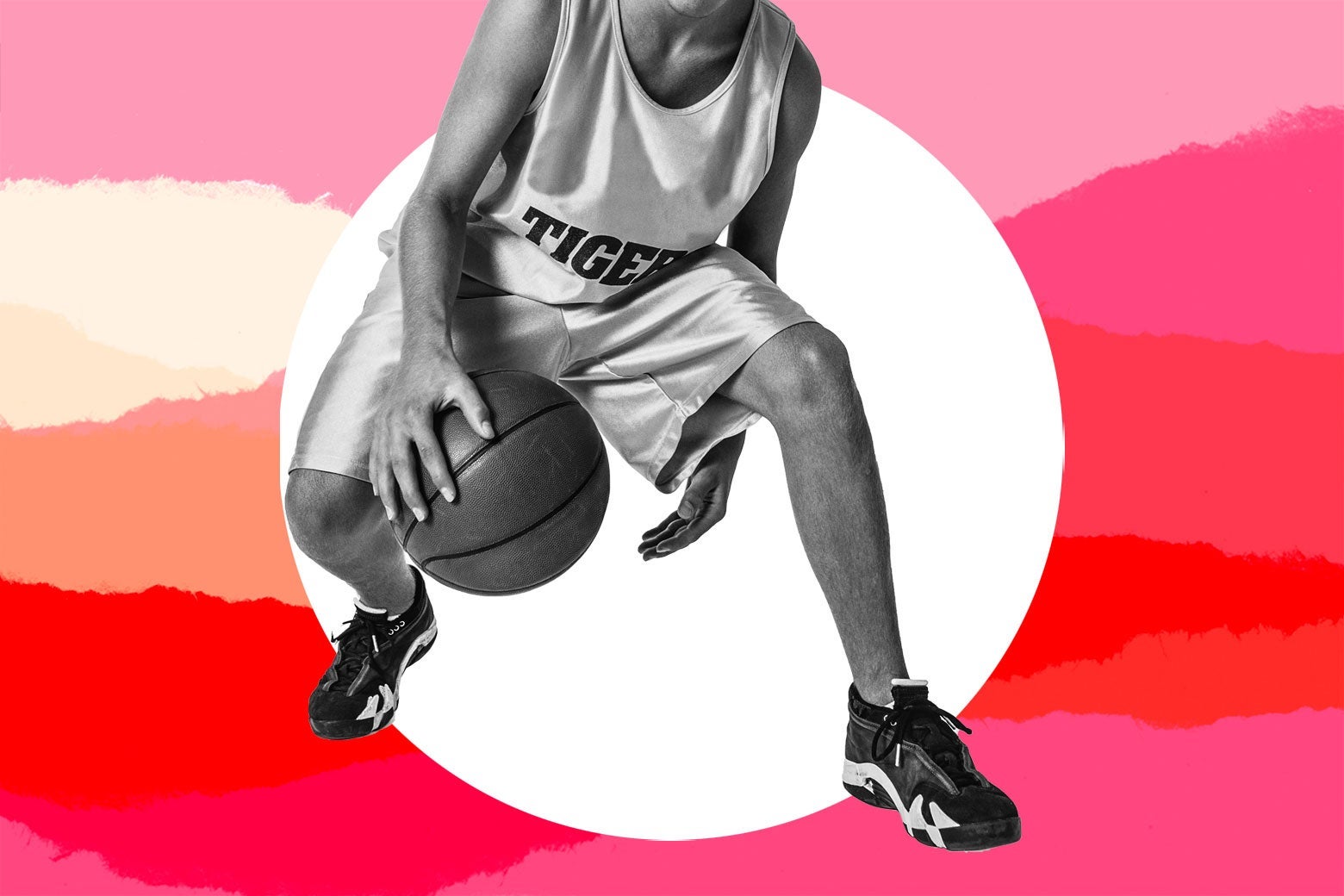 A teen boy plays basketball.