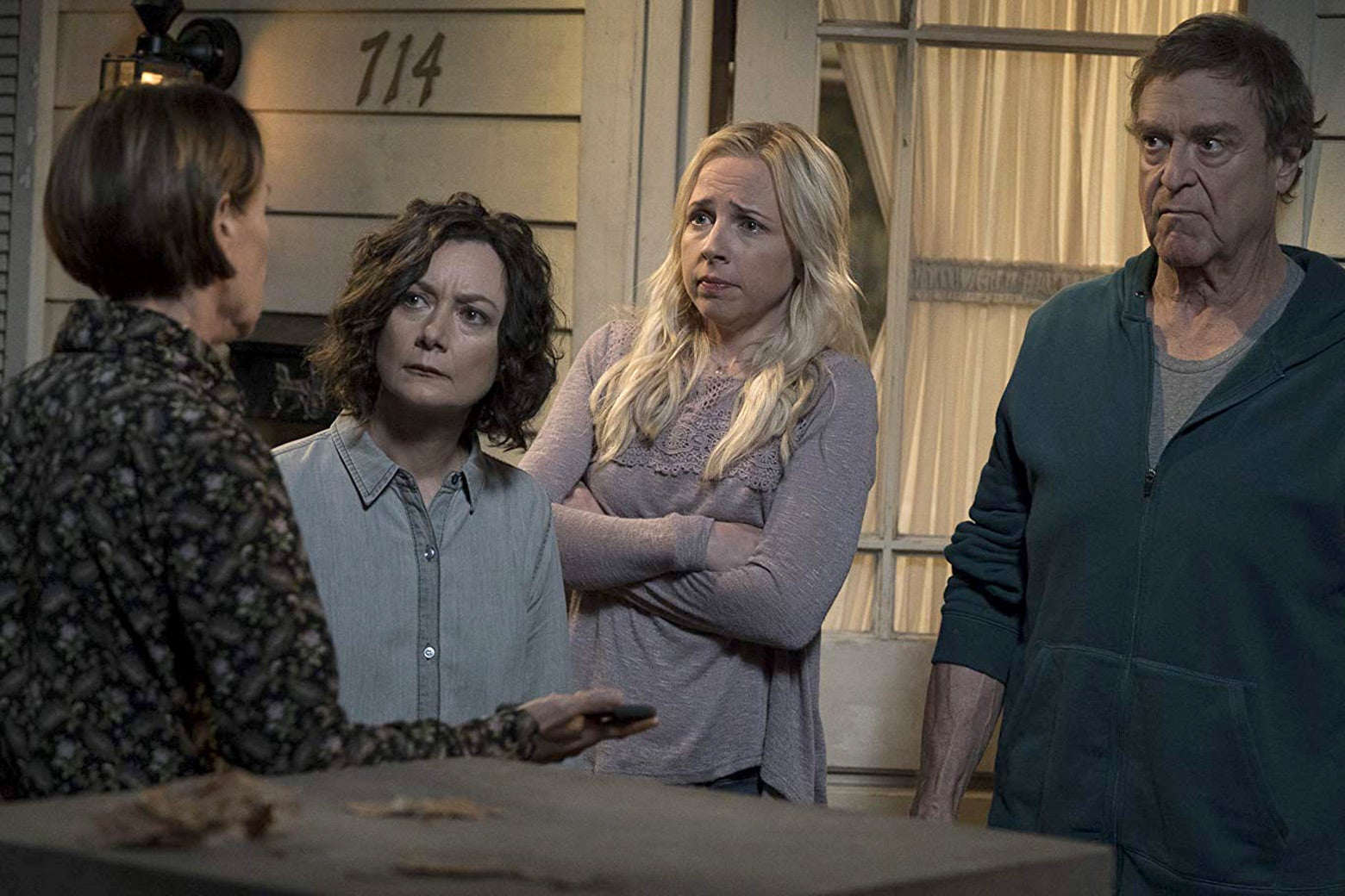 In a scene from The Conners, Darlene, Becky, and Dan listen to Jackie.