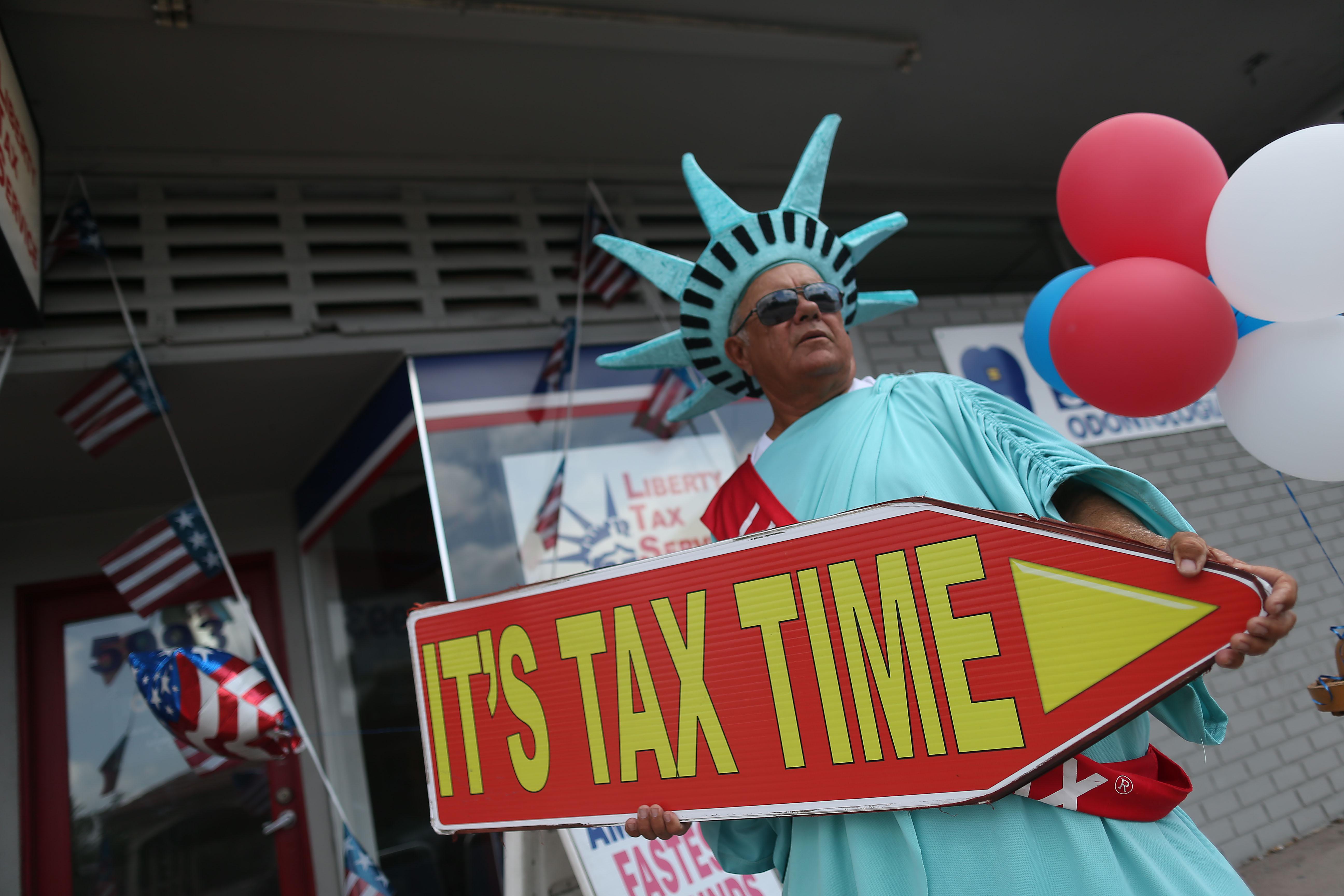 MIAMI, FL - APRIL 15:  Armando La Rosa directs people to the Liberty Tax Service office as the deadline to file taxes looms on April 15, 2016 in Miami, Florida.  The Internal Revenue Service moved the deadline from April 15th to Monday the 18th due to the Emancipation Day holiday in Washington, D.C.  (Photo by Joe Raedle/Getty Images)