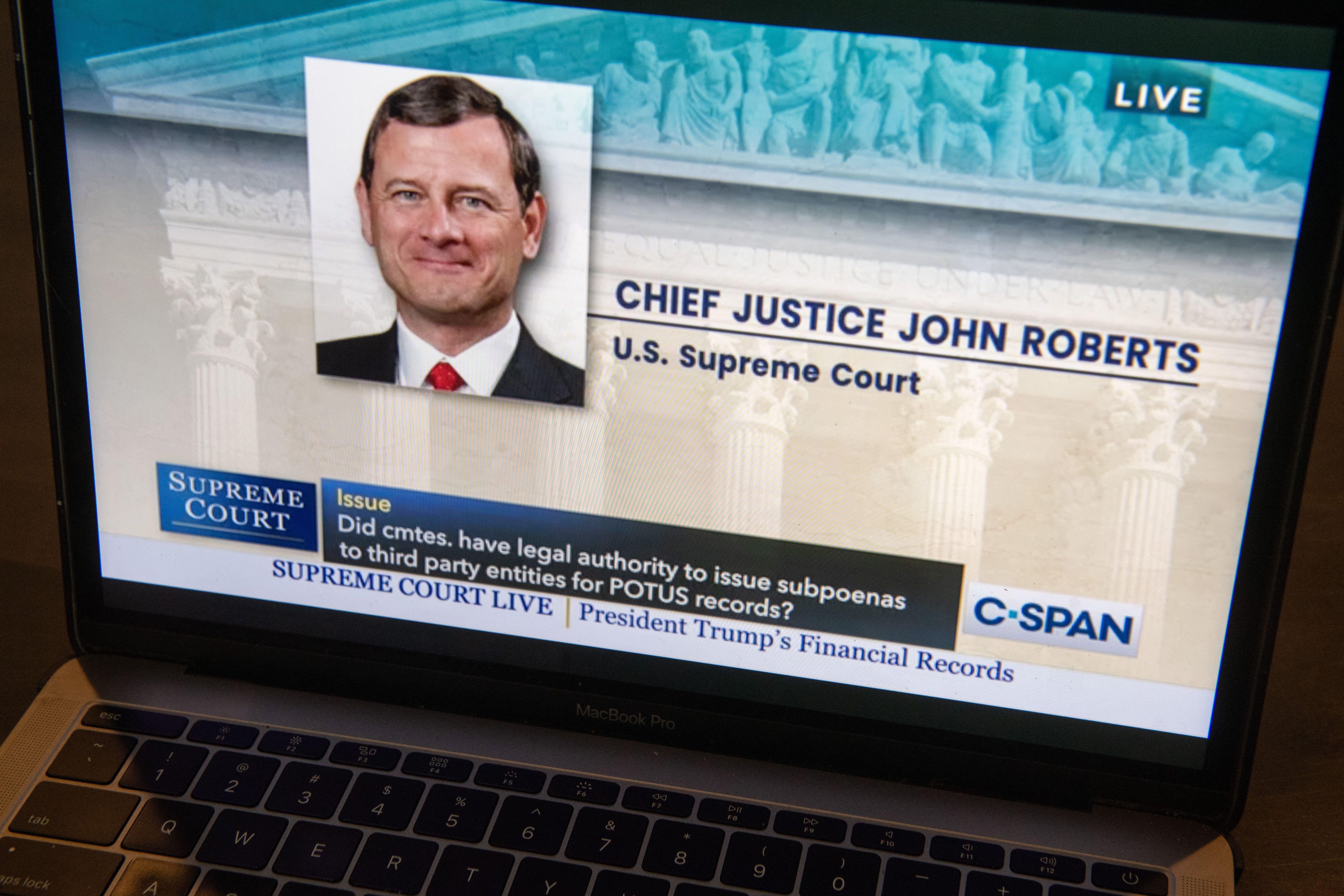 A photo of a computer with John Roberts' face on a C-Span presentation of live oral arguments.
