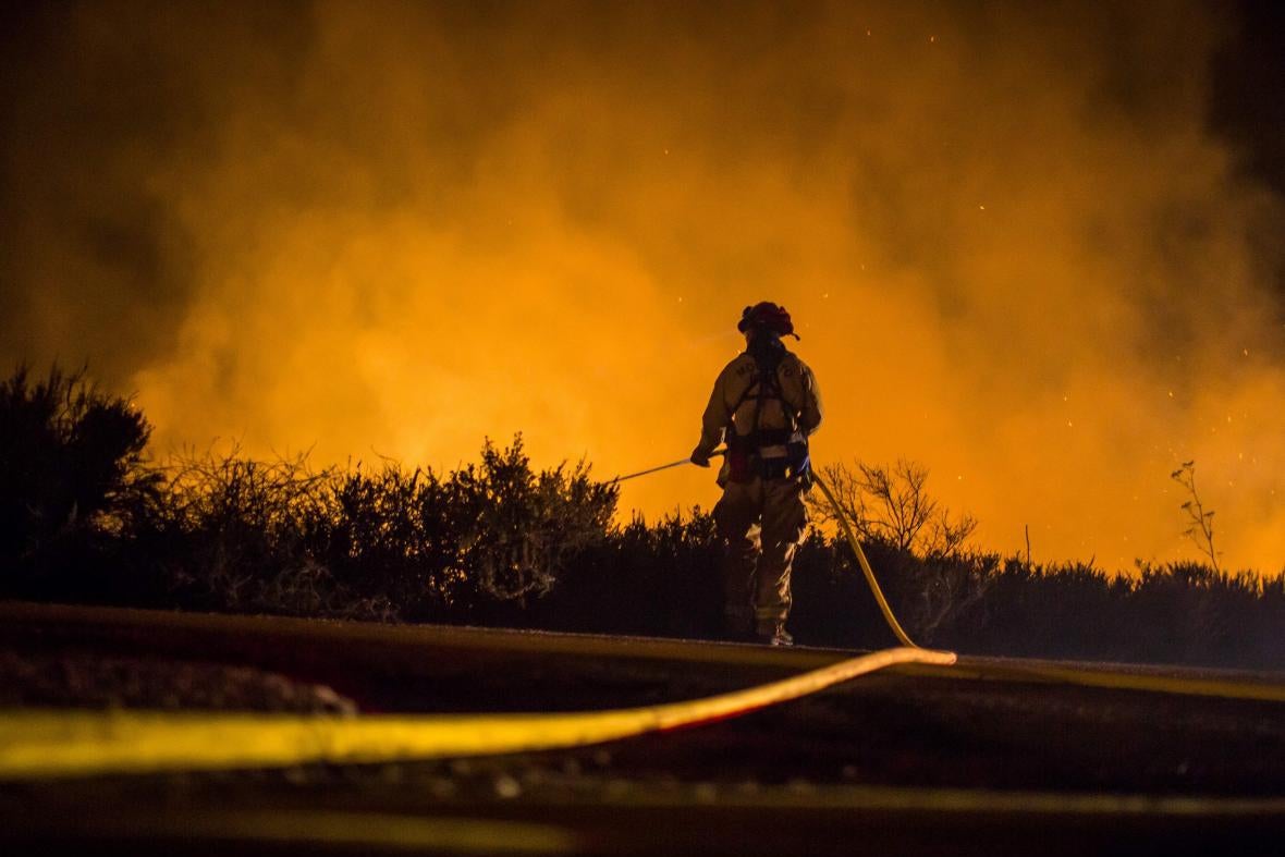 Firefighters work to extinguish the Thomas fire in Ventura, California, on Thursday.