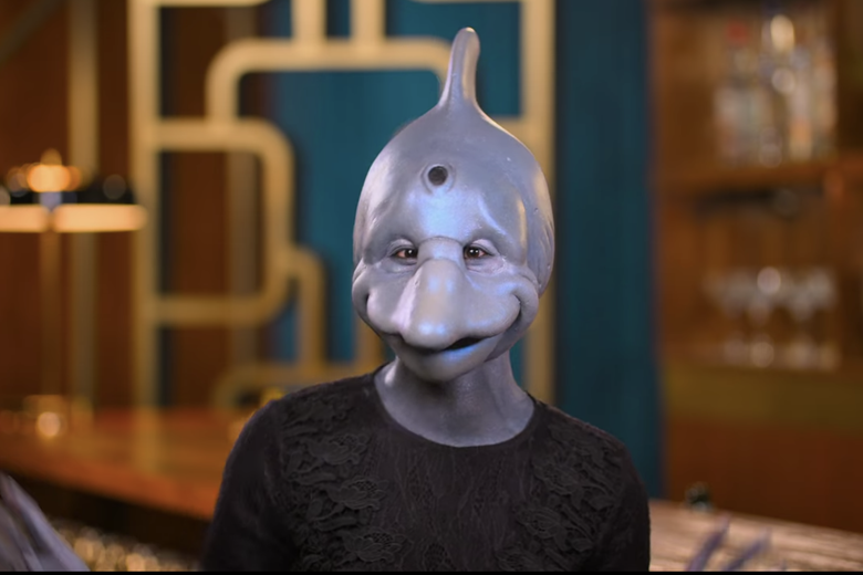 Woman in black shirt with a dolphin head.