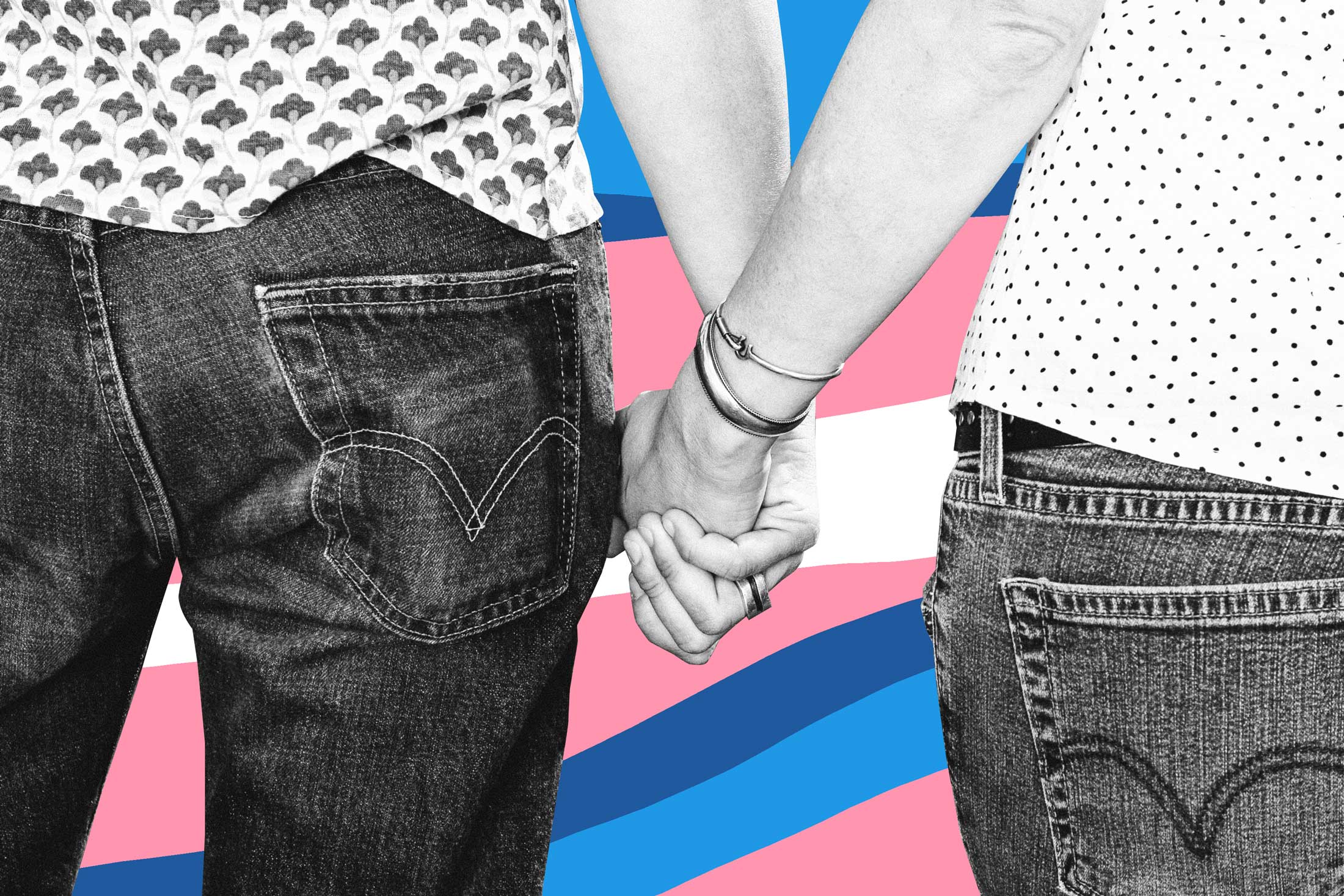 Two women holding hands, trans flag color motif in background.