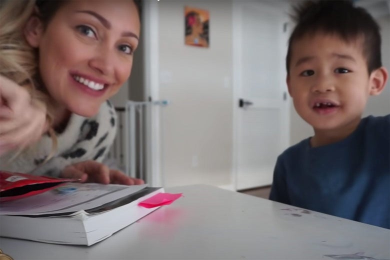 A blond white woman and a smiling Asian child.