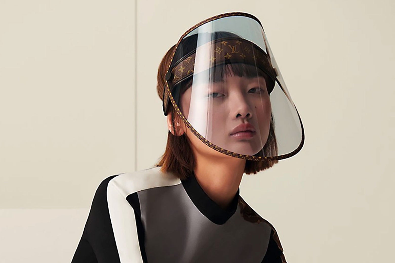a woman wearing a plastic shield over her face 