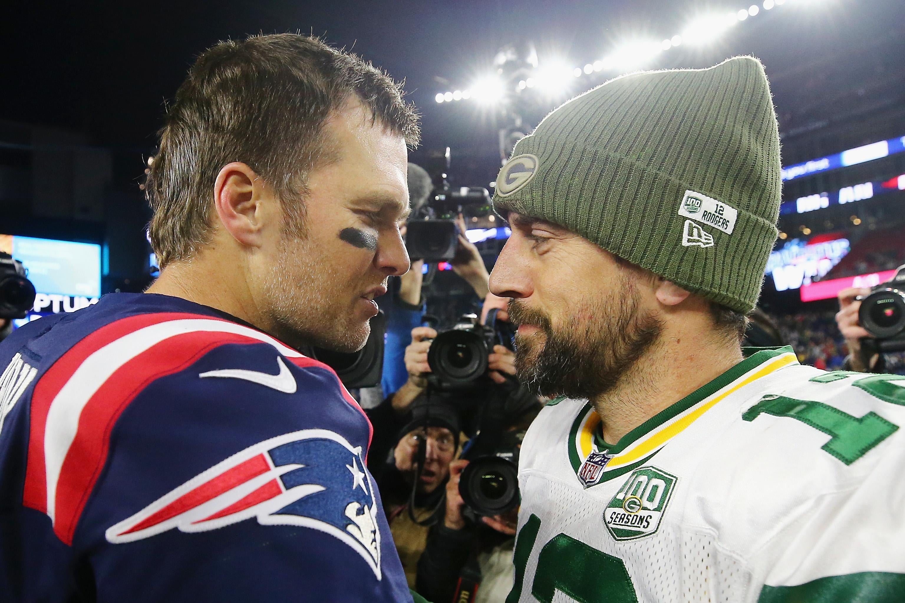 Tom Brady stands face to face with Aaron Rodgers for a postgame chat on the field