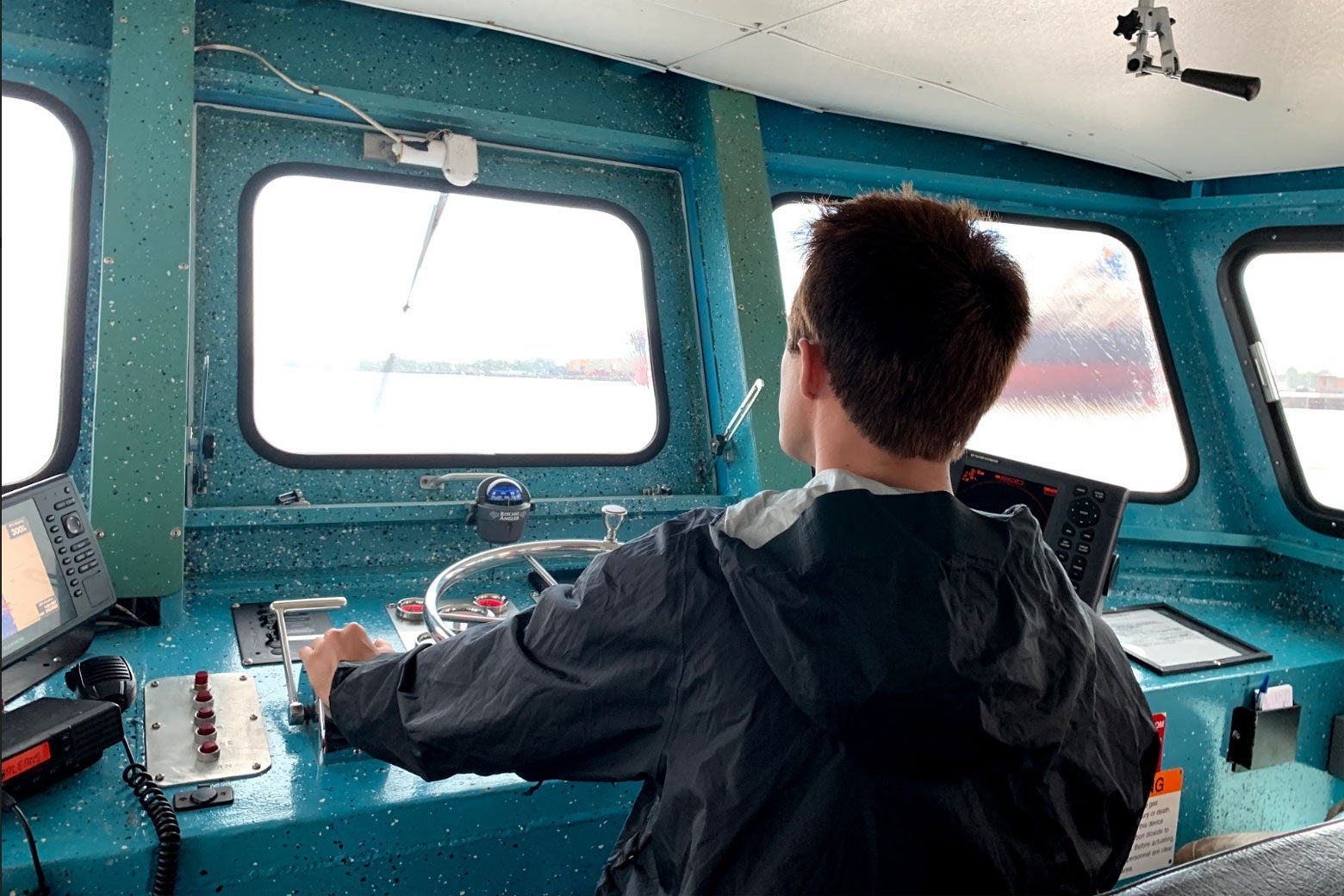 A man steers a boat.