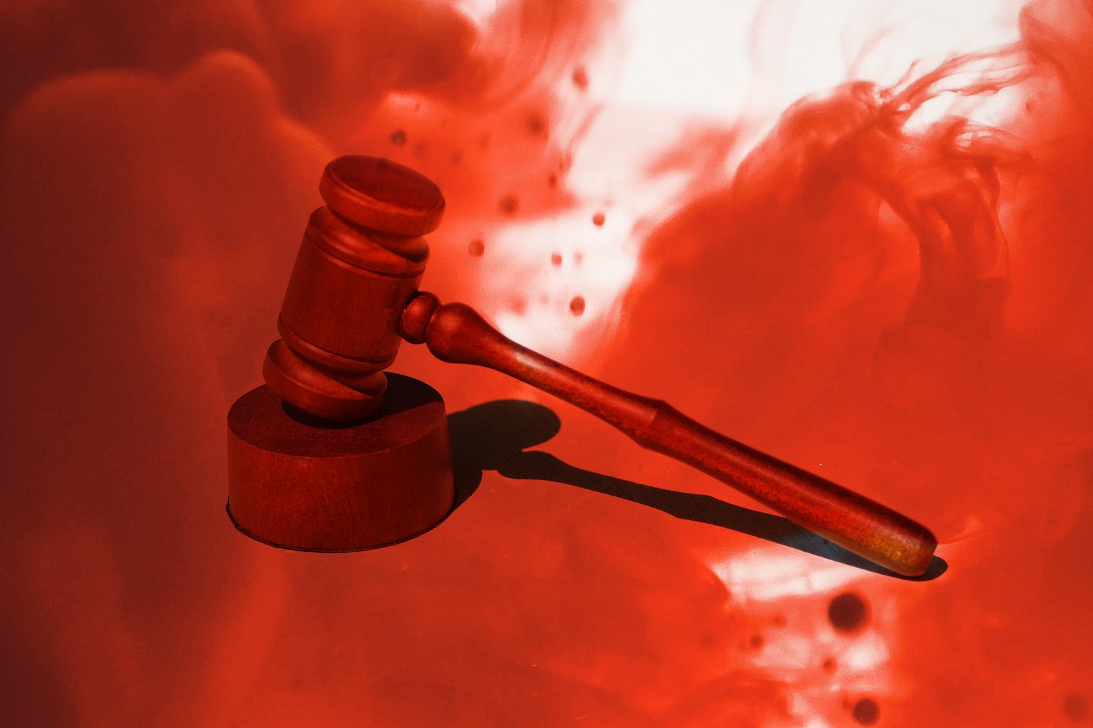A gavel illustrated with a cloud of red that looks like blood