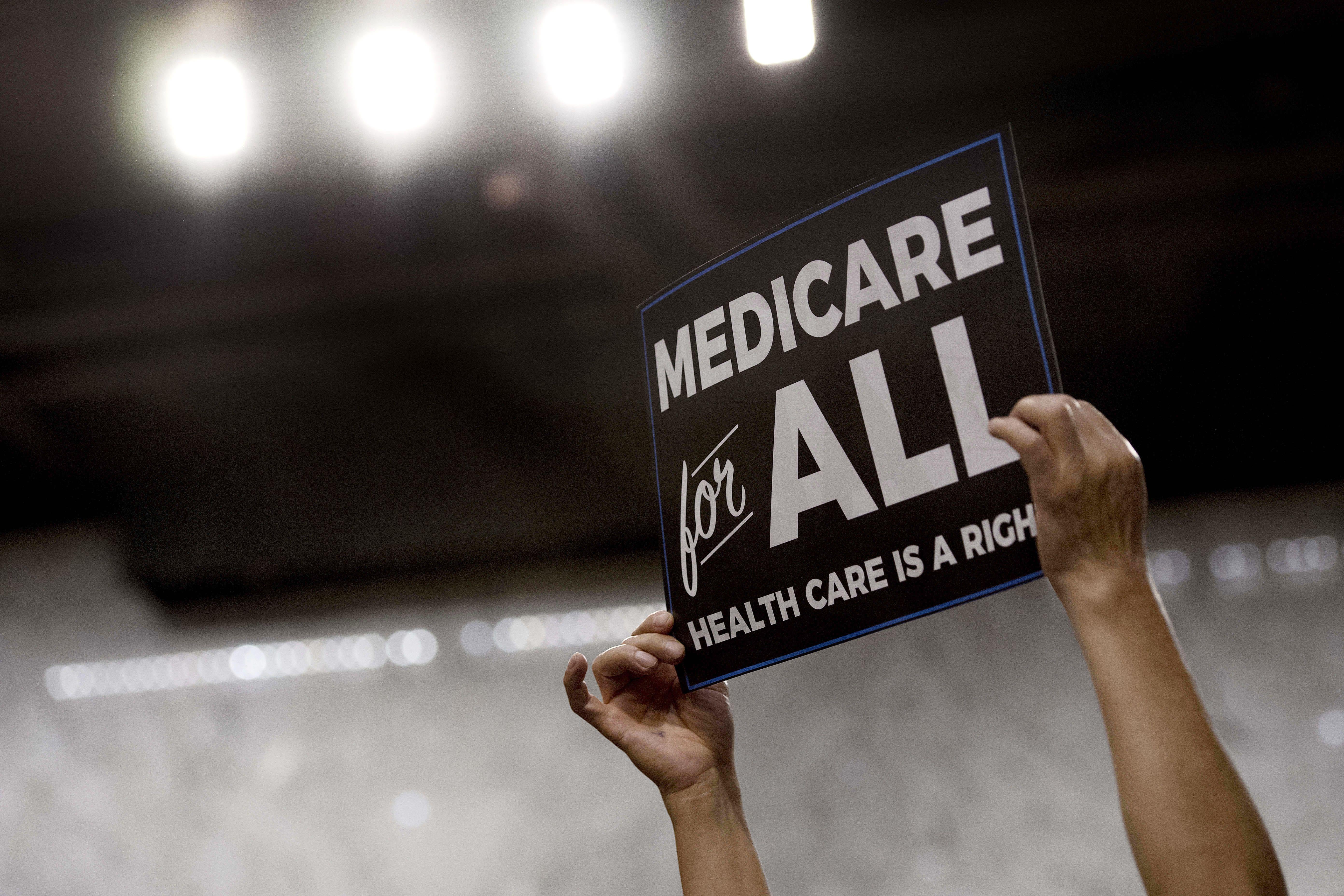 A member of the audience holds up a placard as U.S. Sen. Bernie Sanders, an Independent from Vermont, discusses Medicare for All legislation on Capitol Hill in Washington on Sept. 13.