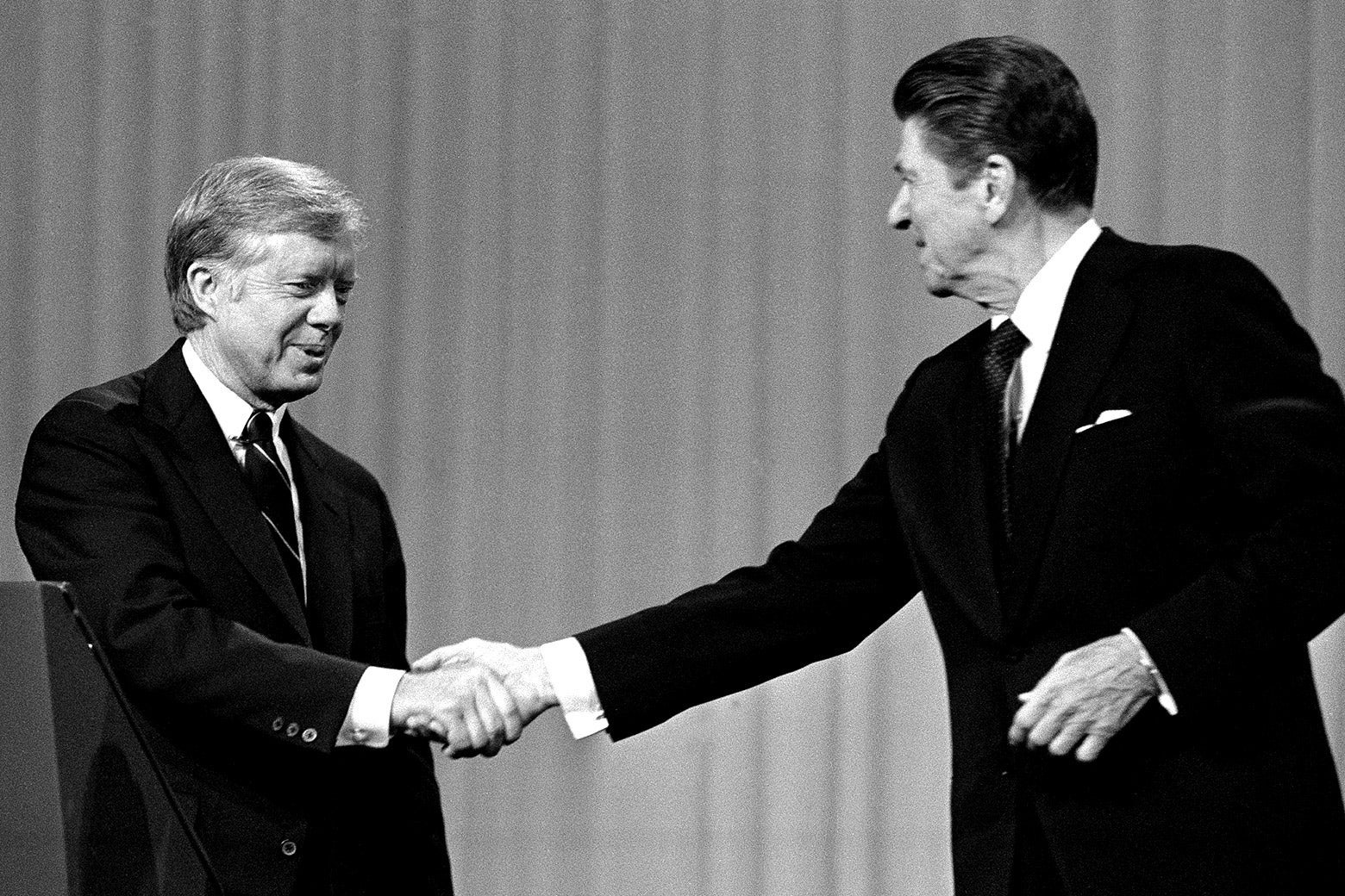 Jimmy Carter shakes hands with Ronald Reagan after debating.