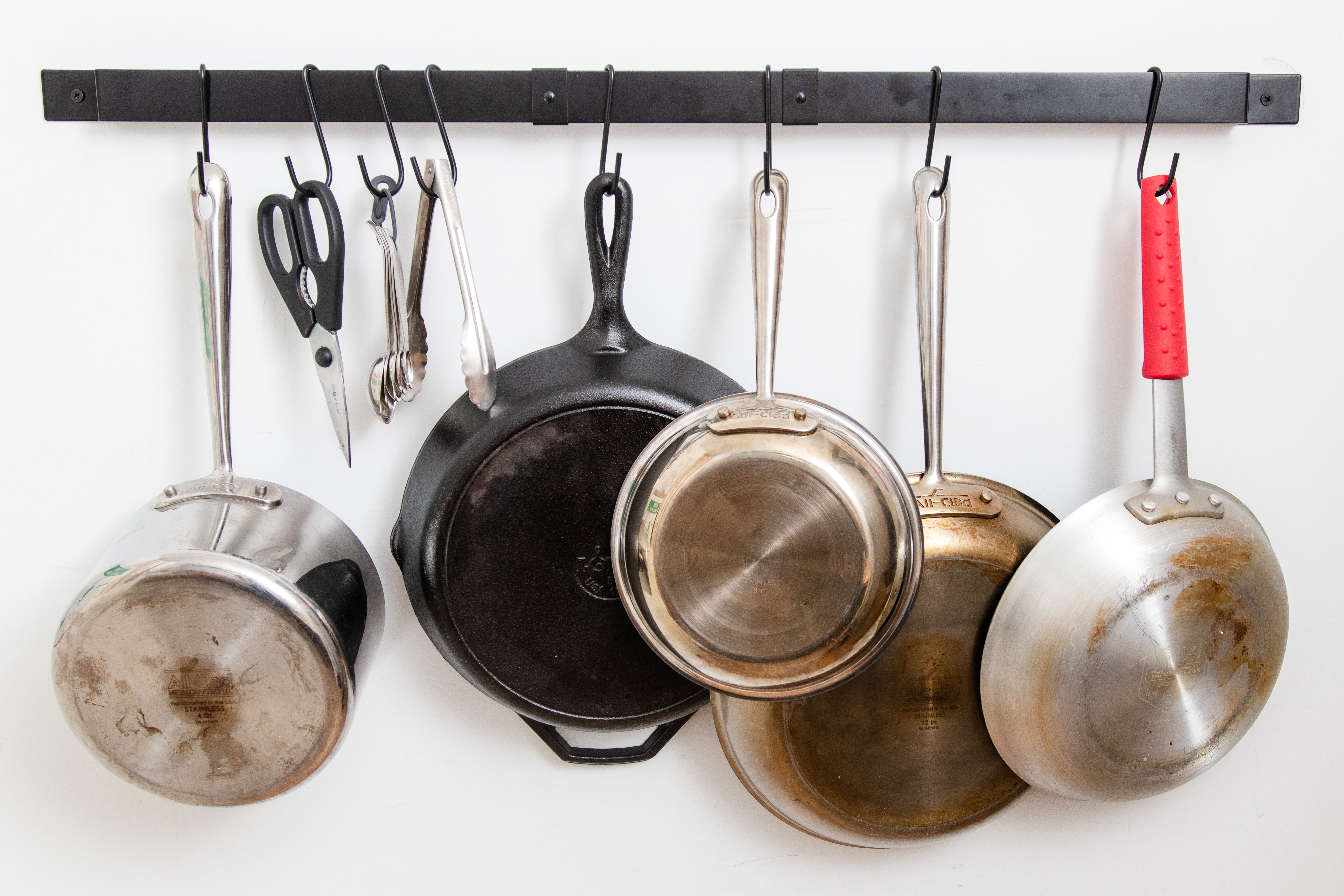 Range Kleen’s expandable pot rack with pots hanging.
