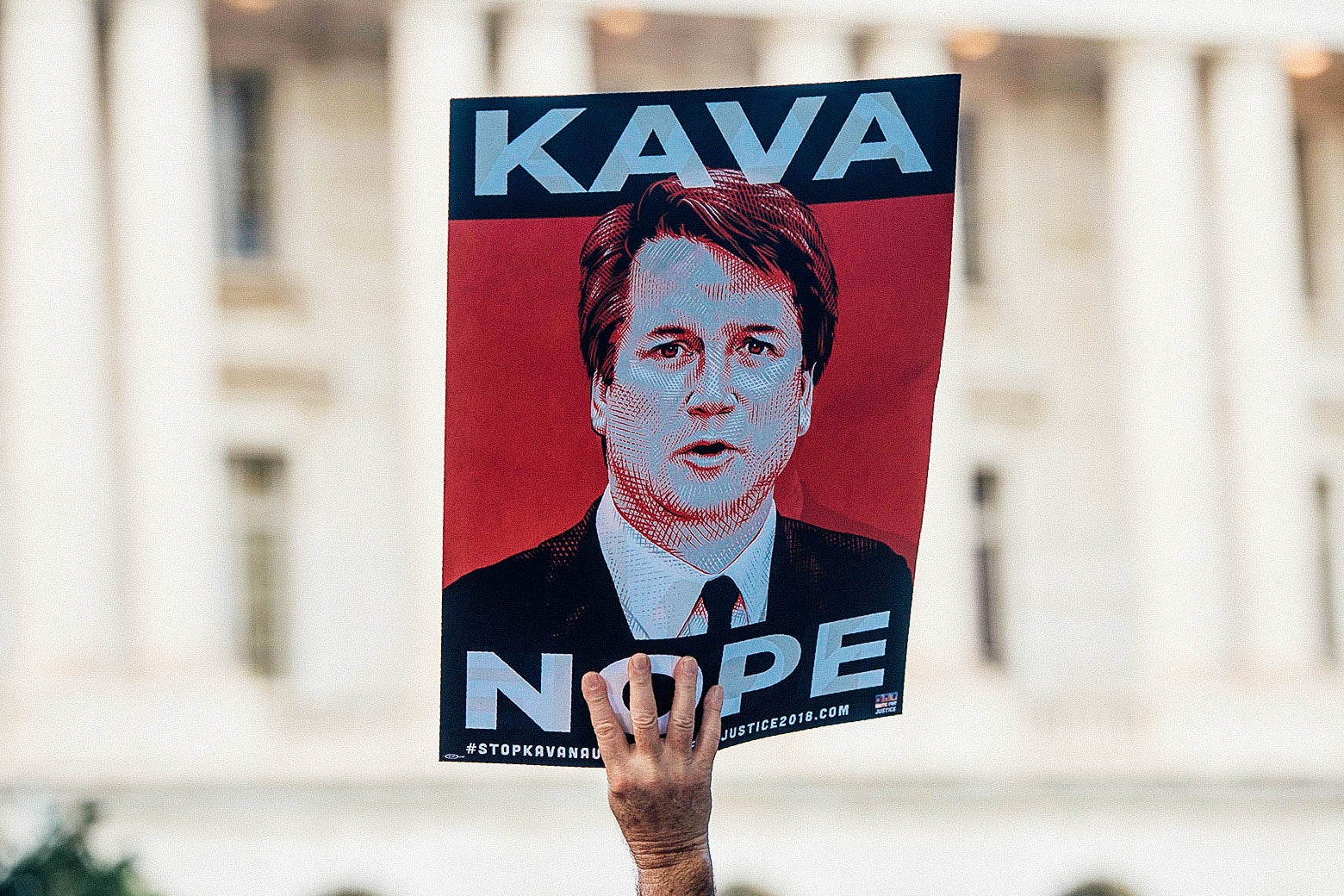 A protester holds a sign that says "KAVA NOPE" at a rally near Capitol Hill on Sept. 4