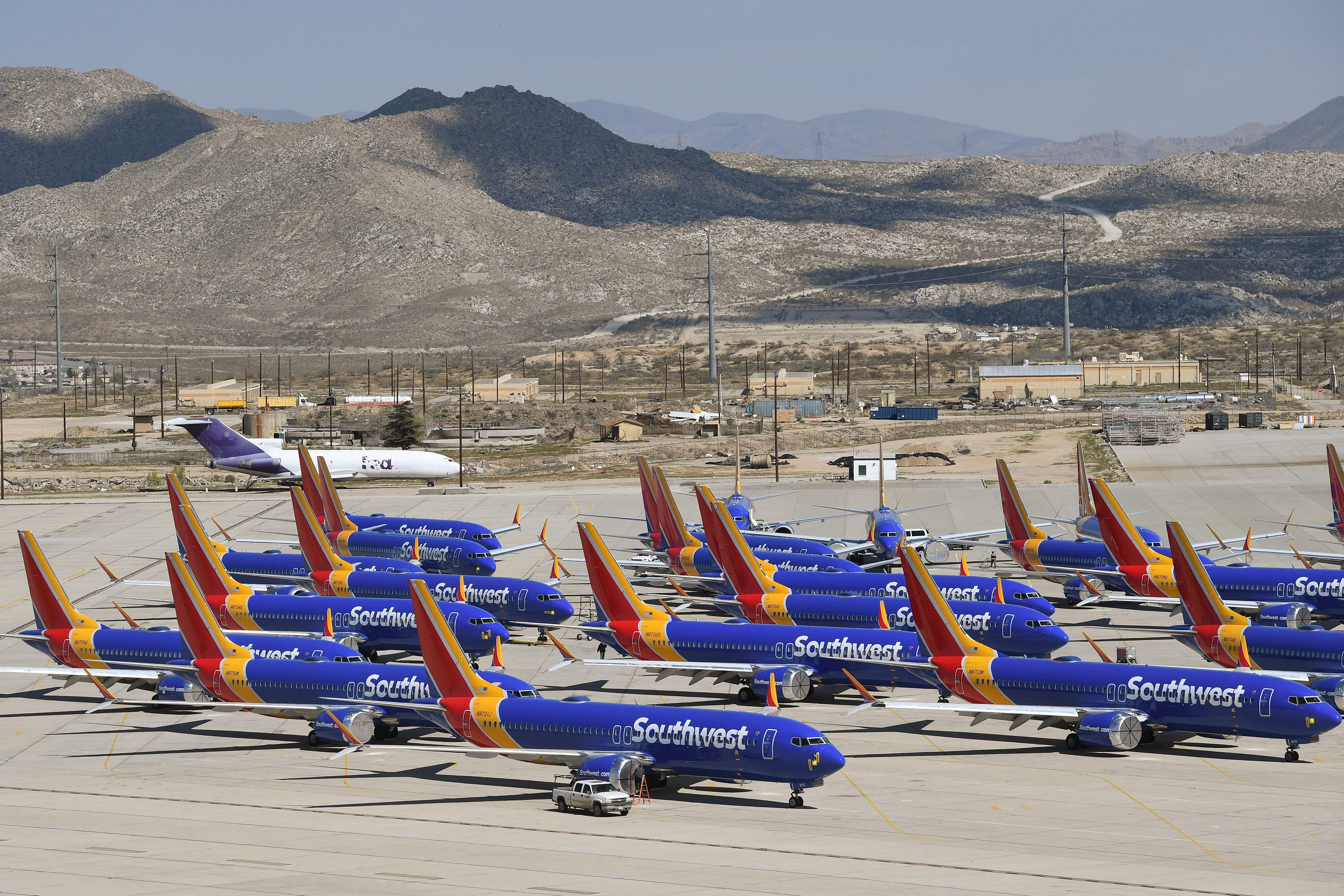 A number of Southwest Airlines Boeing 737 MAX aircraft are parked on the tarmac.