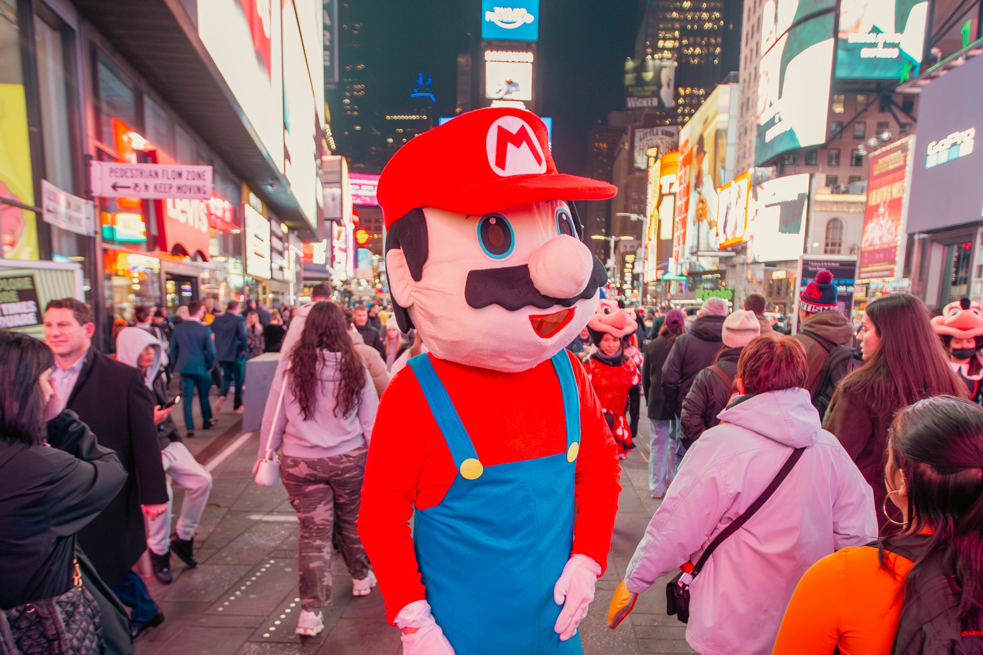 Luke, dressed as Mario, makes his way through the Times Square crowd.