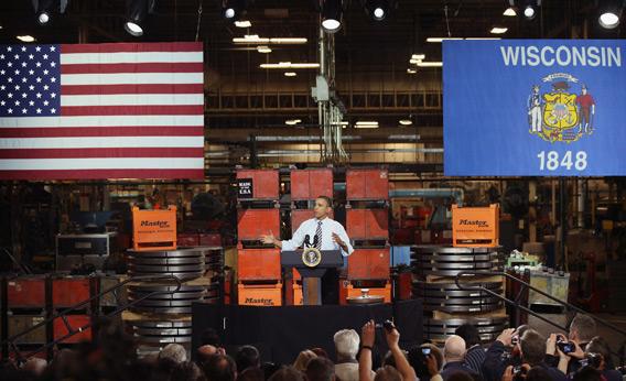 Barack Obama speaks to workers at a factory 