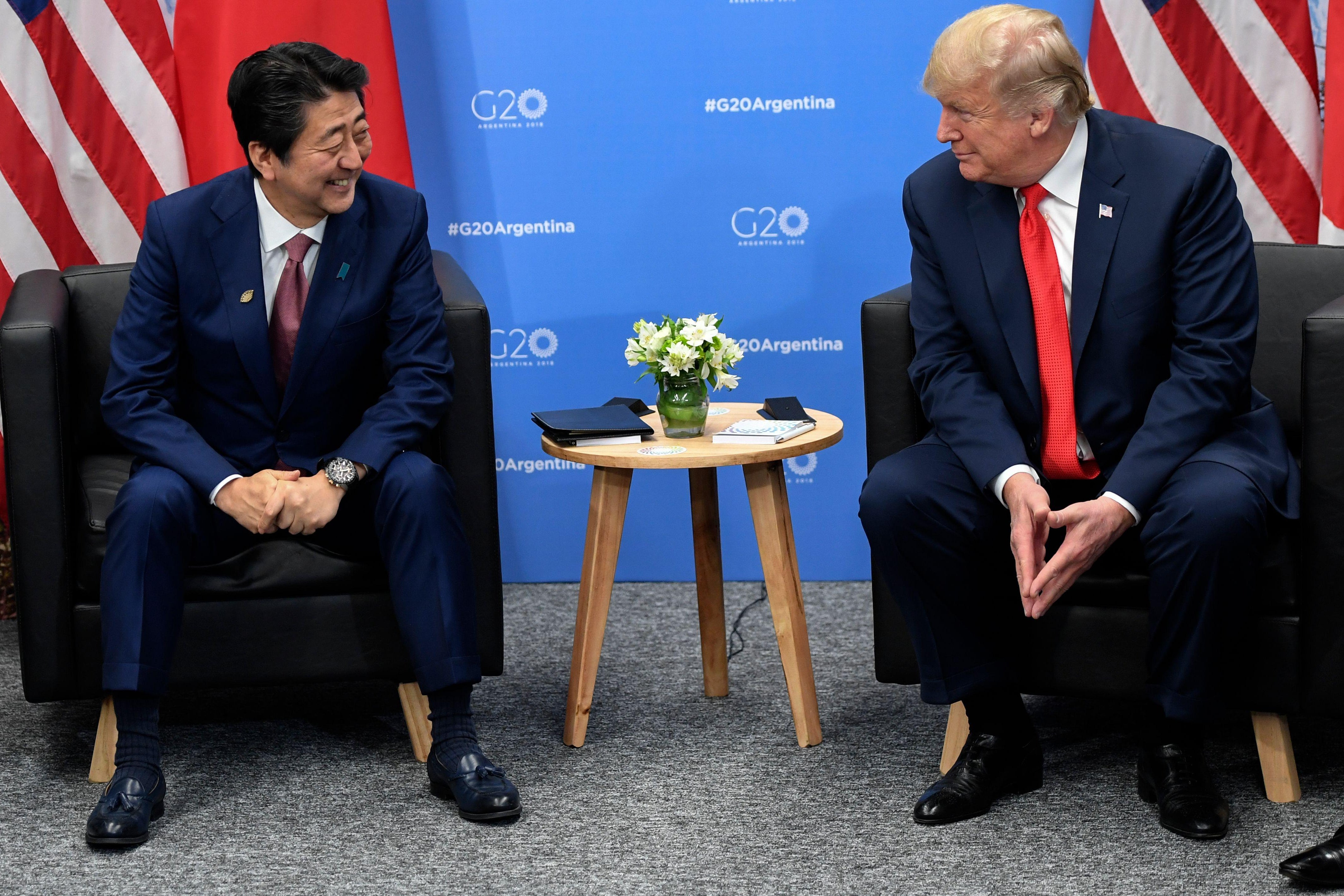 President Donald Trump speaks with Japan's Prime Minister Shinzo Abe in the sidelines of the G20 Leaders' Summit in Buenos Aires, on November 30, 2018. 