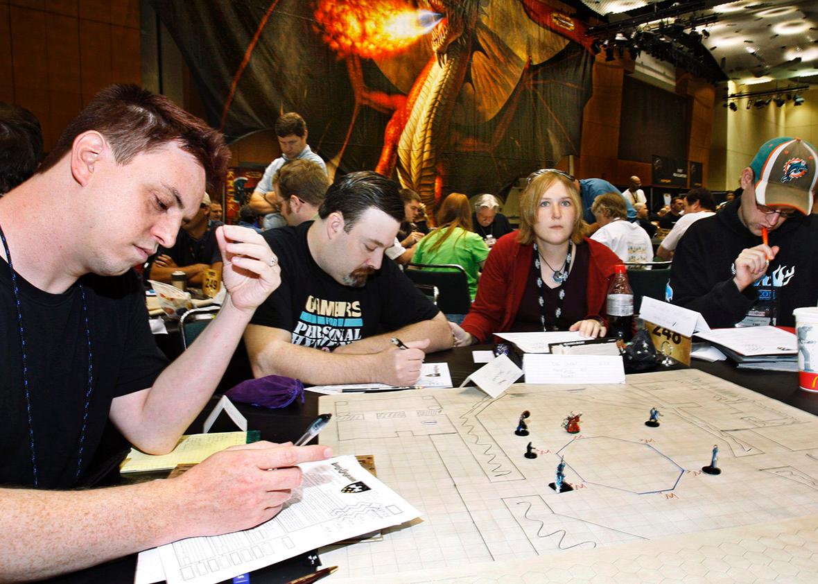 Brandon Stanley, Milwaukee, Wisconsin; Micheal Adams Exeter, New Hampshire; and Kristi and Peter Ladvienka, Kenosha, Wisconsin, join gamers who play Wizards of the Coast's Dungeons and Dragons game during the 40th annual Gen Con game convention at the Indiana Convention Center in Indianapolis, Indiana, August 16, 2007. 