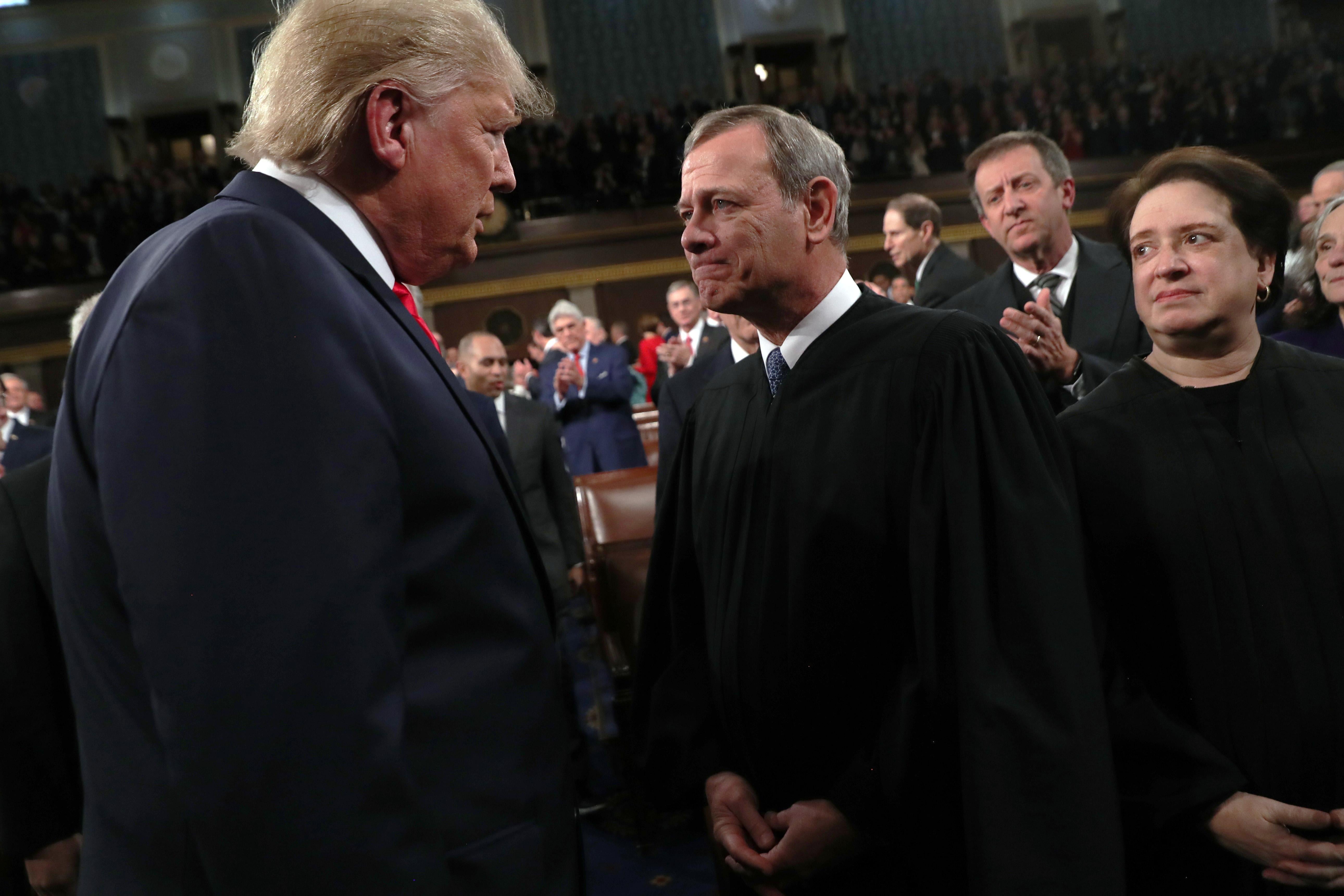 Trump looking like he's staring down Roberts as Kagan looks on.