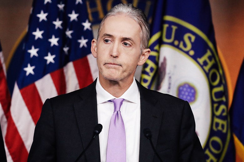 Trey Gowdy stands behind a podium, wearing a lavender tie.
