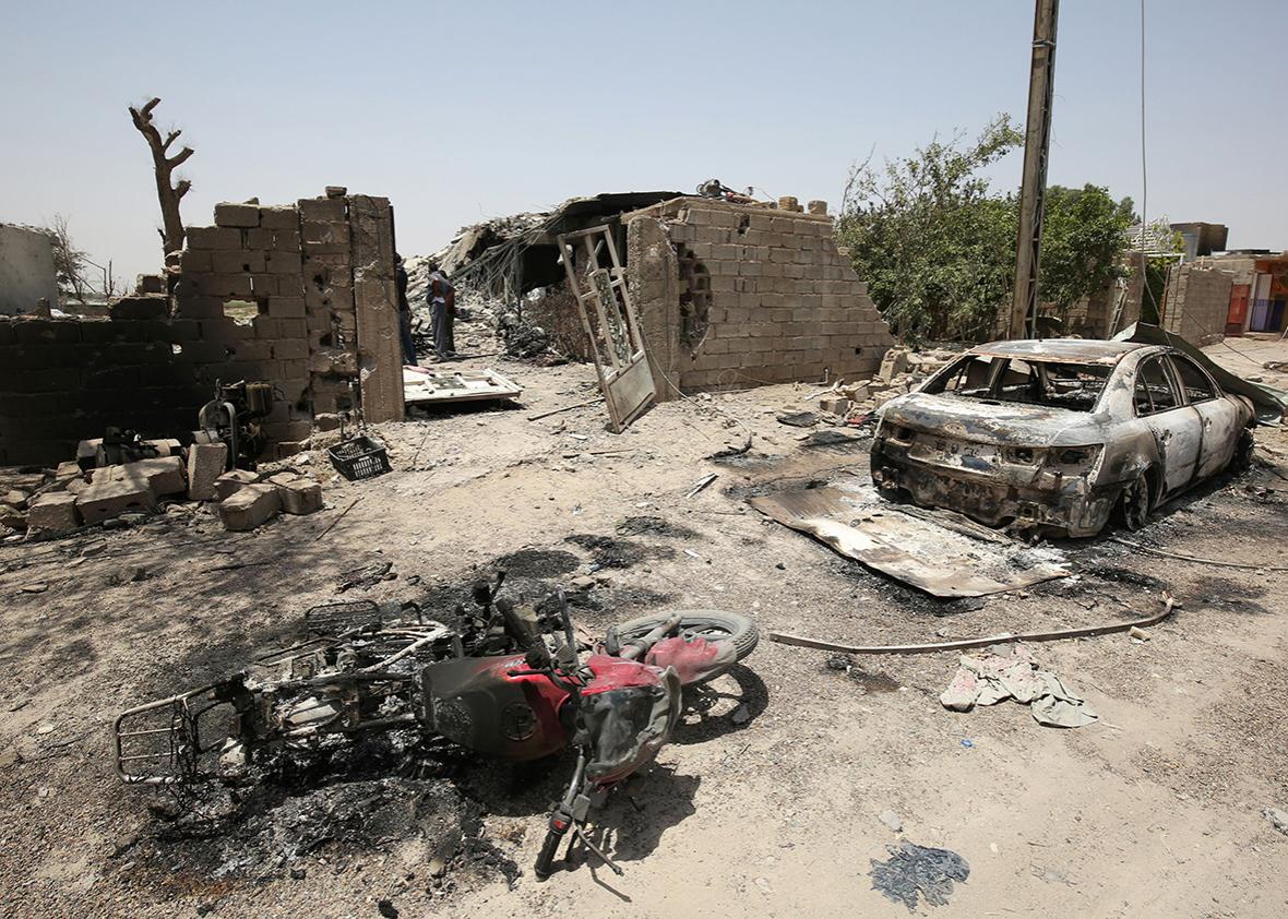 Picture taken on June 30, 2016 shows the remains of damaged vehicles in the city of Fallujah following battles between Iraqi pro-government forces and Islamic State group jihadists.