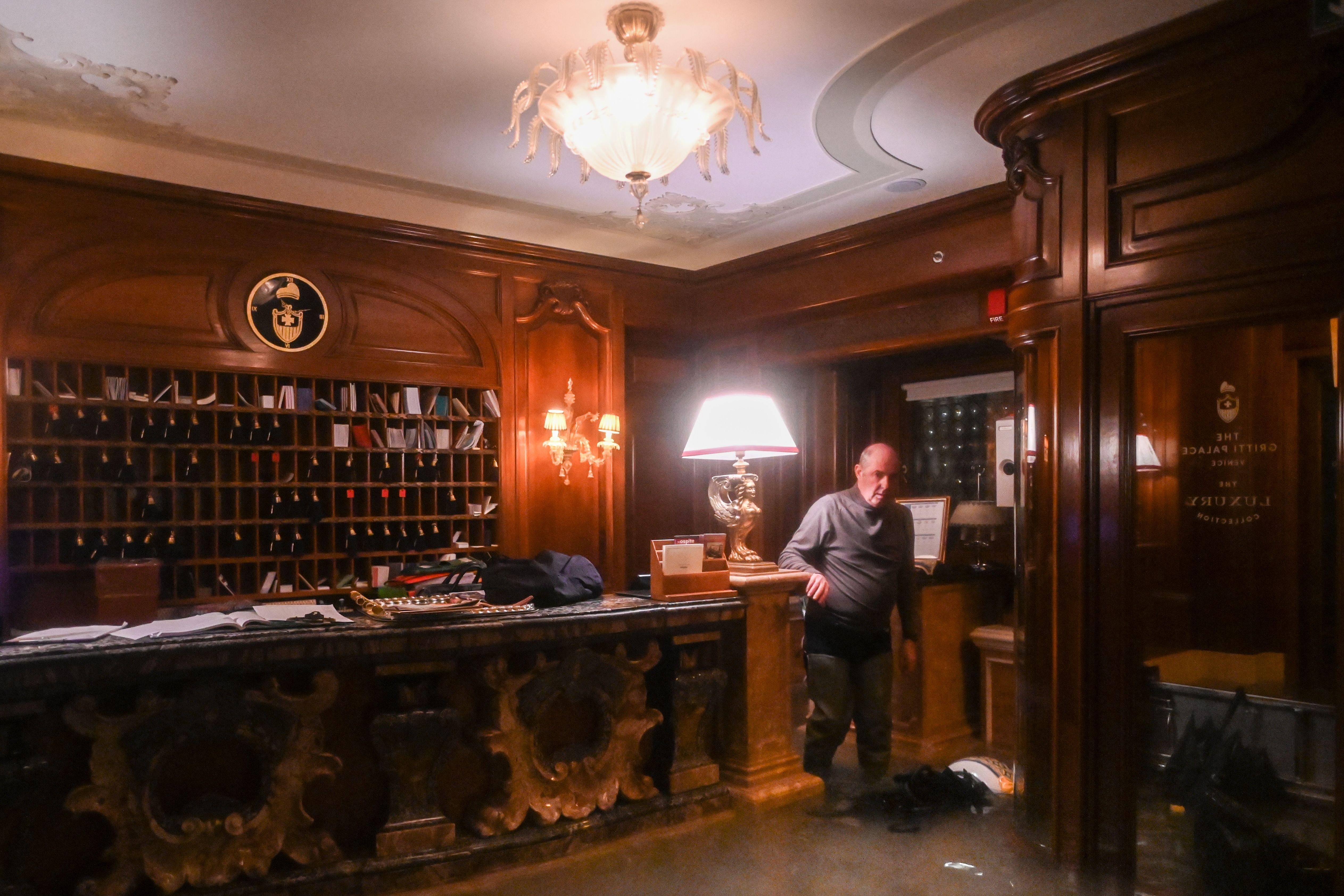 An employee stands by the flooded front desk of the Gritti Palace hotel.