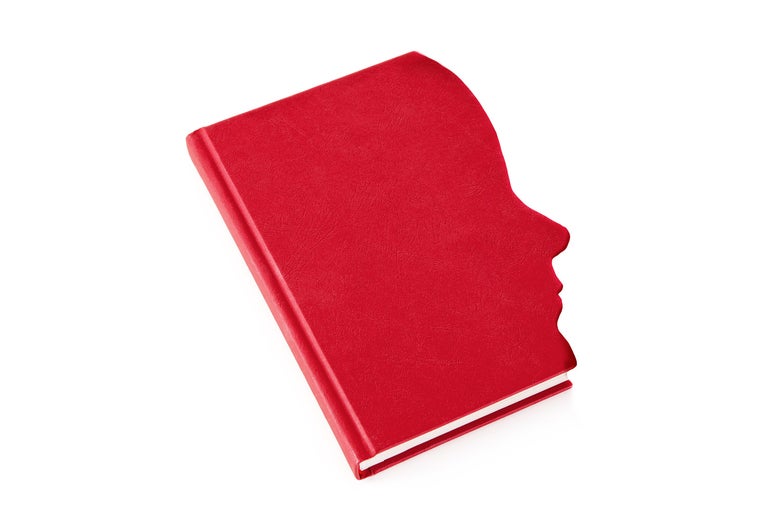 A red book cover with a face in silhouette. 