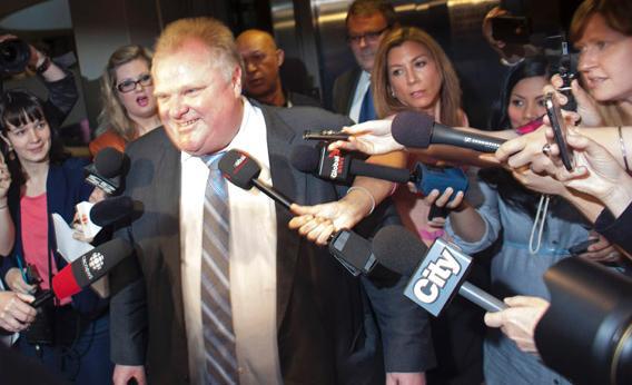 Toronto Mayor Rob Ford is swarmed by reporters as he enters his offices at Toronto City Hall.