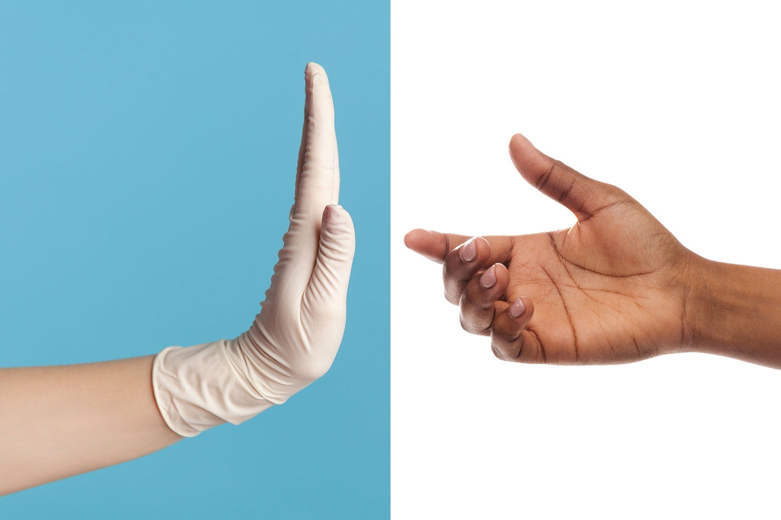 A gloved white hand denies a stretched-out Black hand.