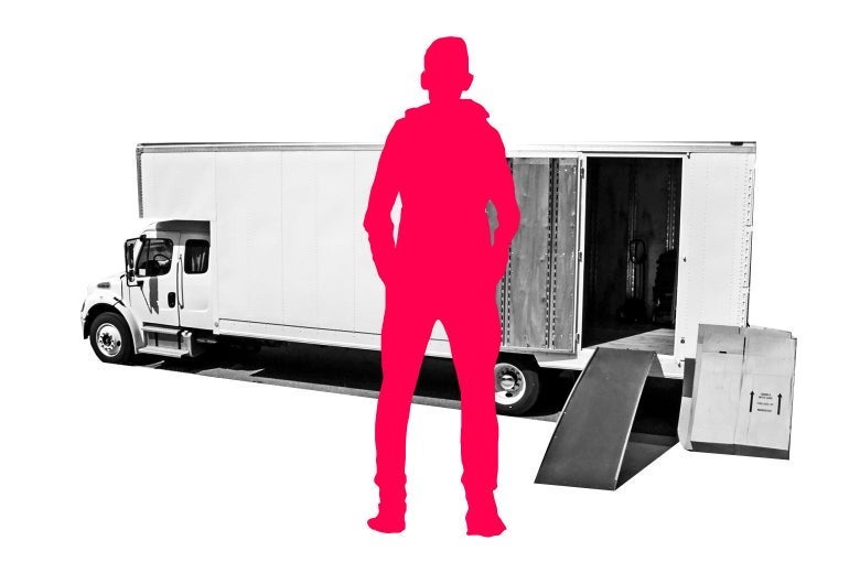 Silhouette of a man standing in front of a moving truck.