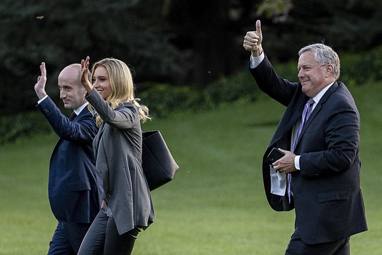 Meadows walking gives the thumbs up while the other two wave.