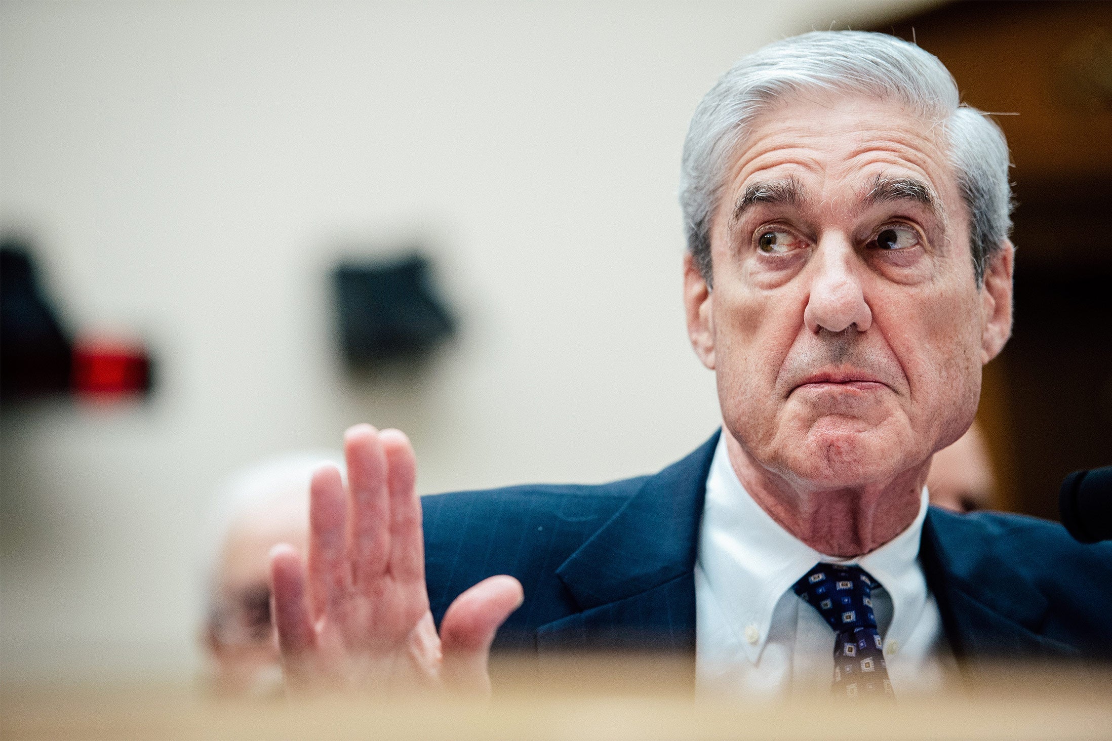 Mueller raising his hand as if in rebuttal.