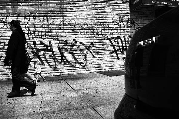 People walk along a street near where two people were murdered i