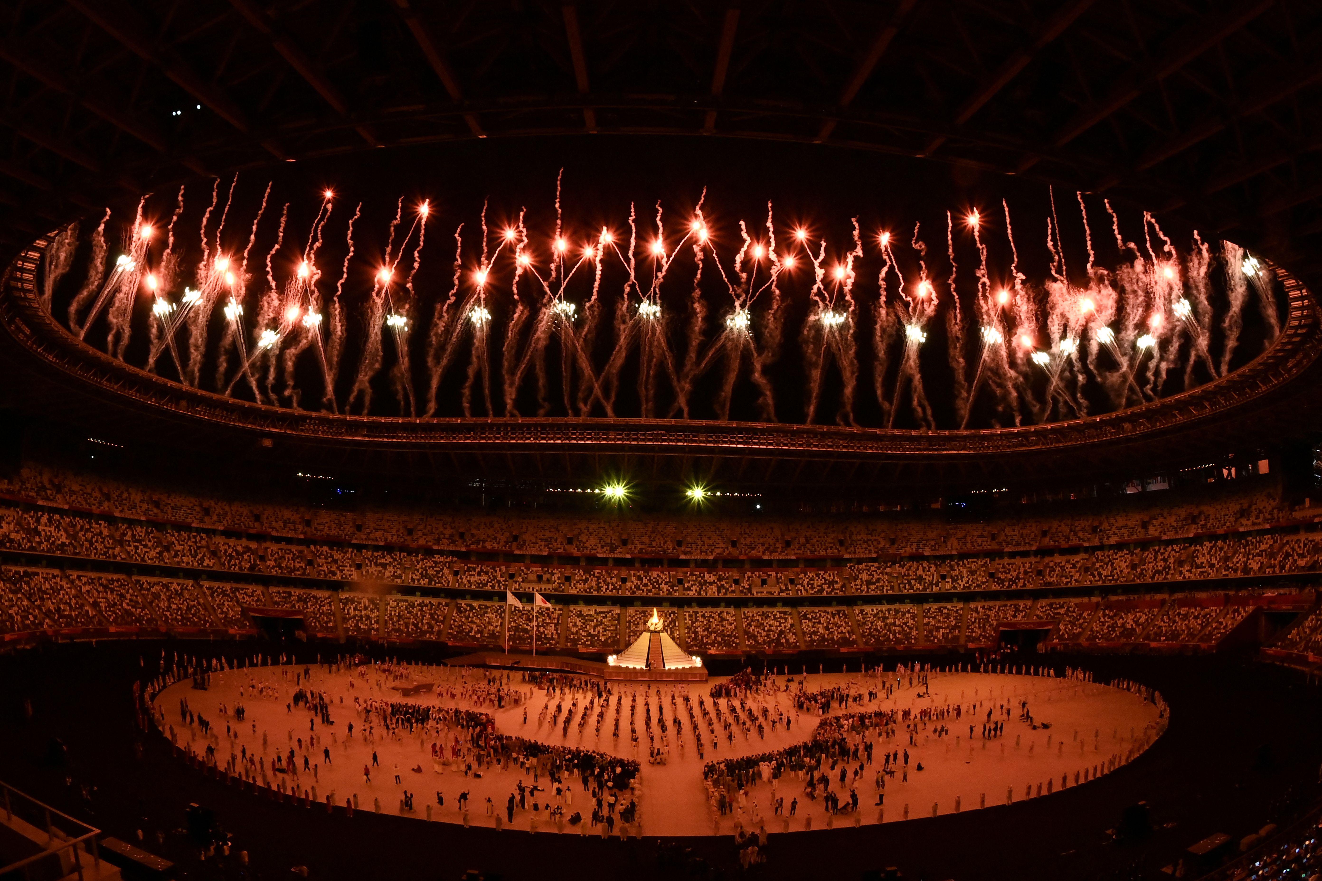 Fireworks go off around the Olympic Stadium after the lighting of the Olympic Flame during the opening ceremony of the Tokyo 2020 Olympic Games, in Tokyo, on July 23, 2021. (Photo by Jewel SAMAD / AFP) (Photo by JEWEL SAMAD/AFP via Getty Images)