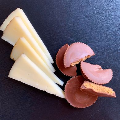 Slices of manchego with pieces of Reese's Peanut Butter Cups