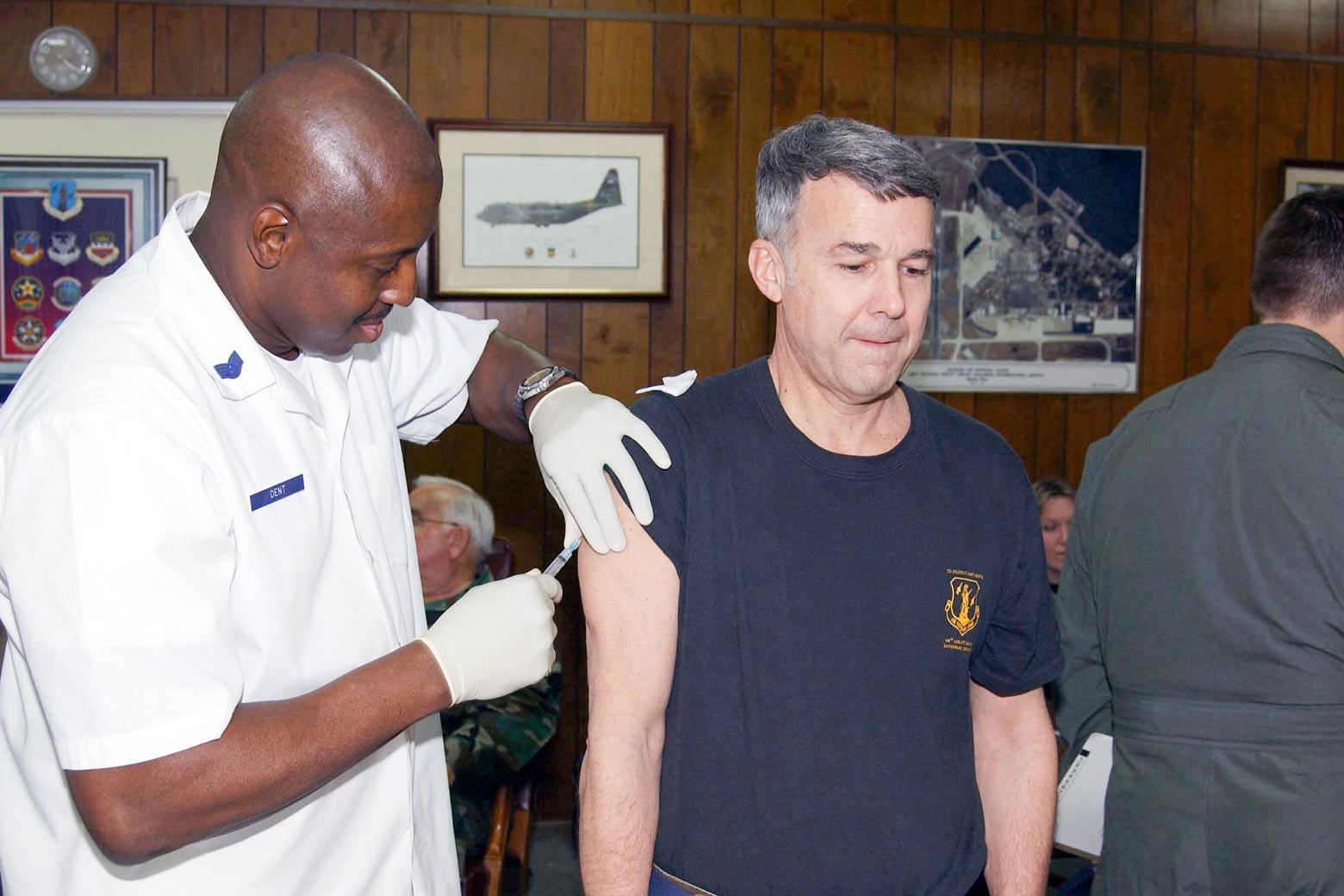 A man gets vaccinated by a health care worker.