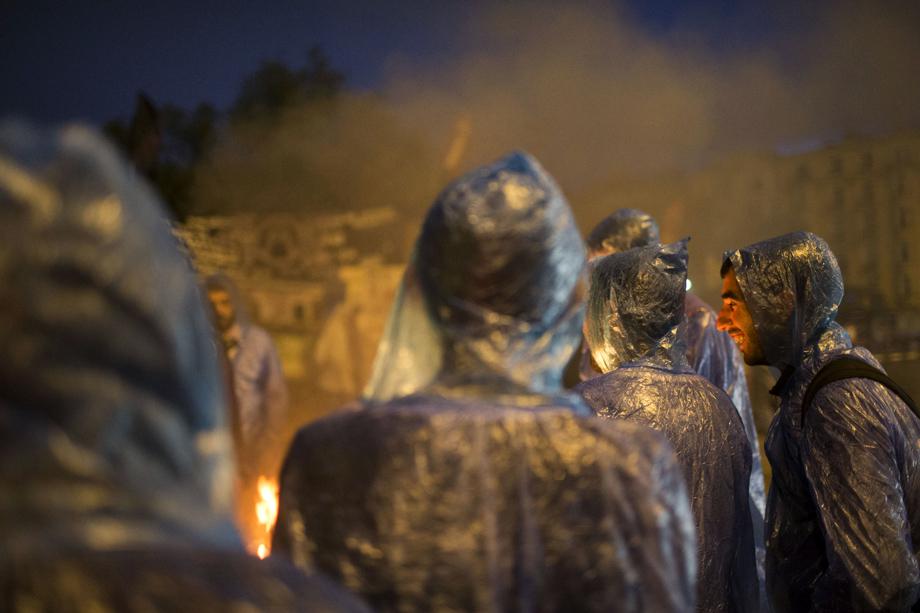 Protesters warm themselves by a fire as morning breaks at the Gezi park in Taksim Squareon June 5, 2013 in Istanbul, Turkey.