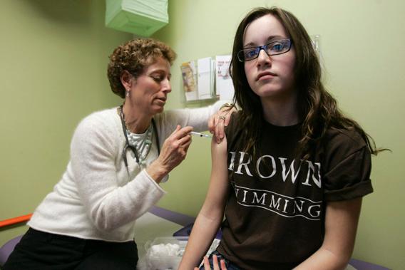 Nancy Brajtbord, RN, (L) administers a shot of gardasil, a Human Papillomavirus vaccine, to a 14-year old patient in Dallas, Texas.
