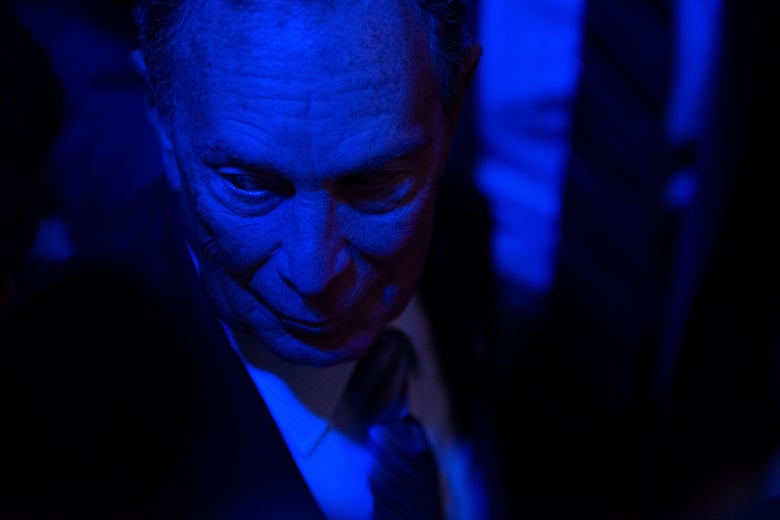 Close shot of Bloomberg in a dark room.