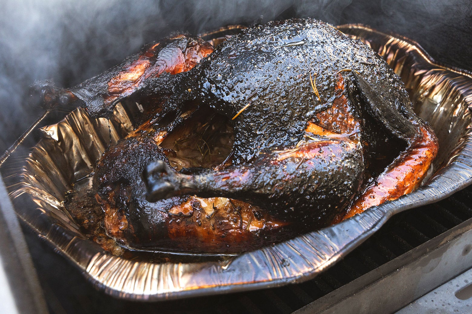 A burnt turkey in an aluminum pan.