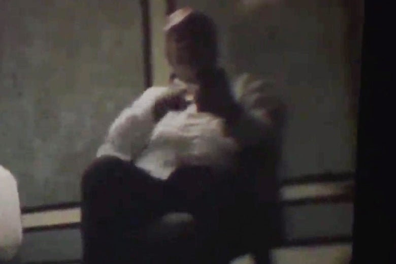 Photo of the Trump-like figure in the video typing on a smartphone.