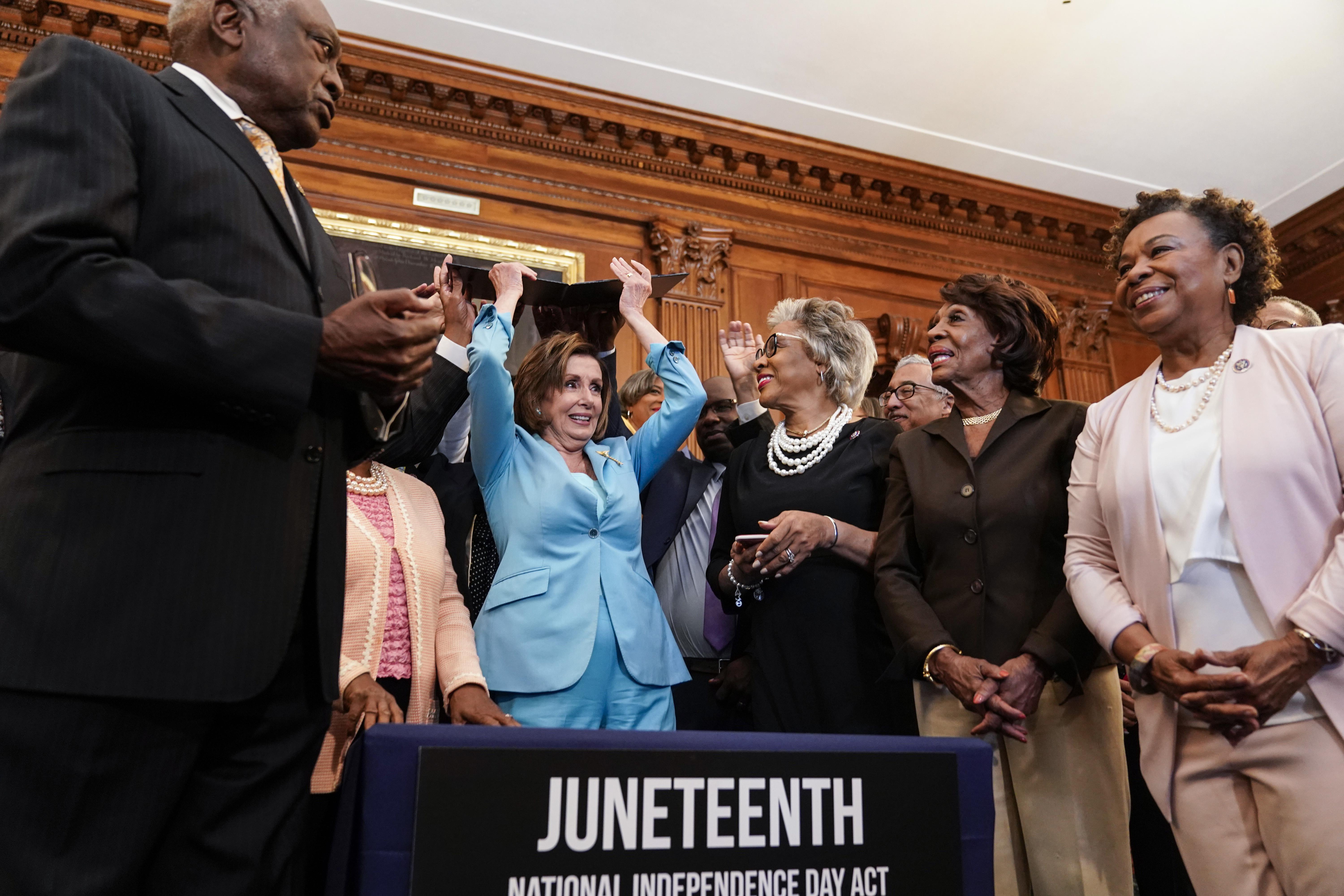 WASHINGTON, DC - JUNE 17: Speaker of the House Nancy Pelosi (D-CA) holds a bill enrollment signing ceremony for the Juneteenth National Independence Day Act as members of the Congressional Black Caucus hold the bill on June 17, 2021 on Capitol Hill in Washington, DC. Juneteenth, celebrated on June 19th,  commemorates the of the end of slavery in the United States and will be celebrated as a national holiday. (Photo by Joshua Roberts/Getty Images)