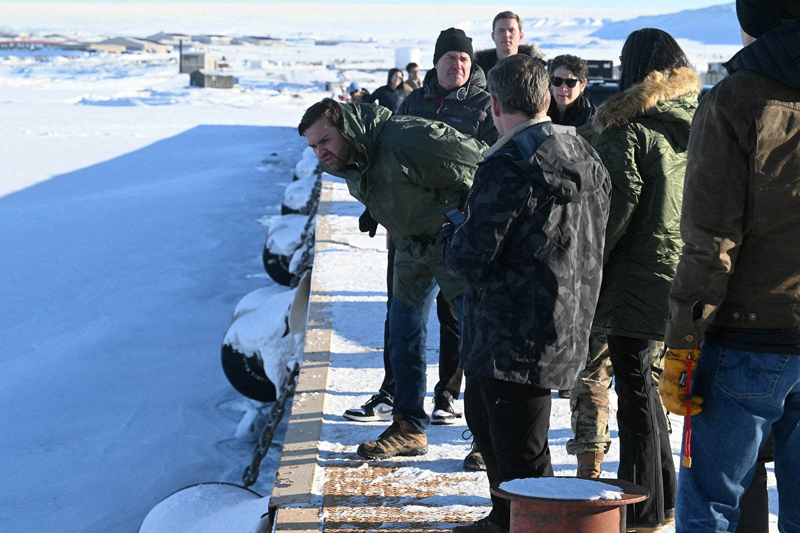 JD Vance staring intently at a patch of snowy ground in Greenland.