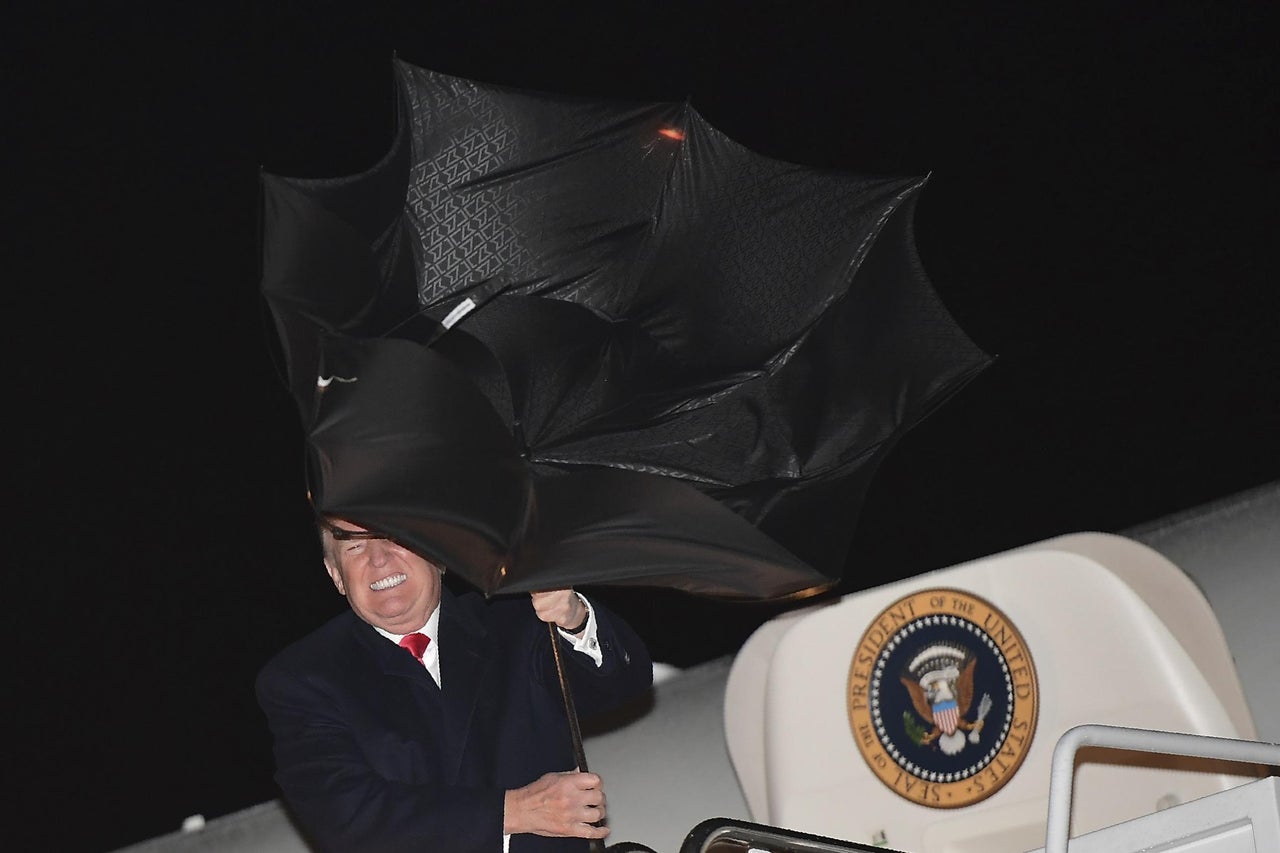 Watch Trump struggle and fail to control unruly umbrella as metaphor ...
