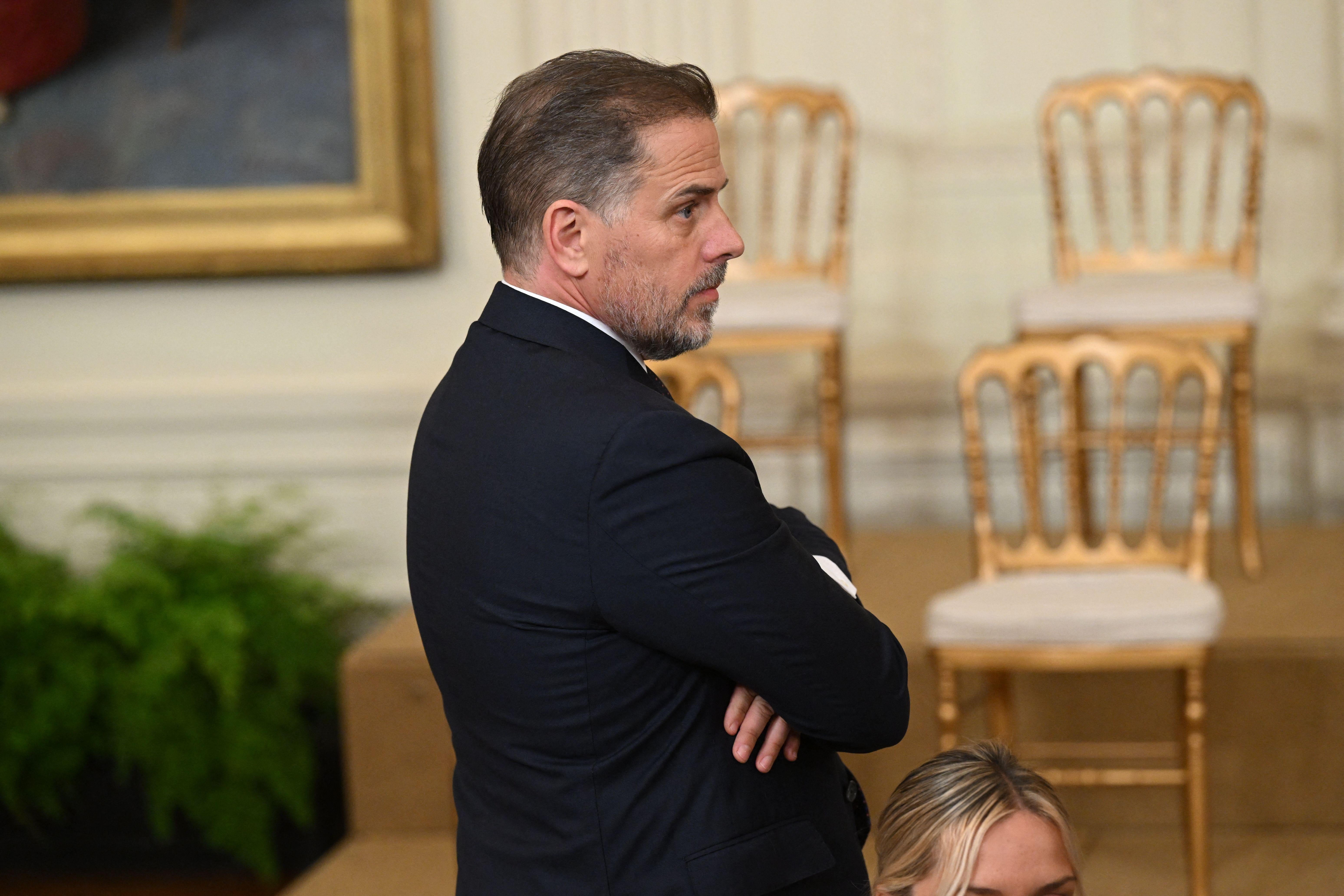 Hunter Biden, crossing his arms, is seen from his right profile.
