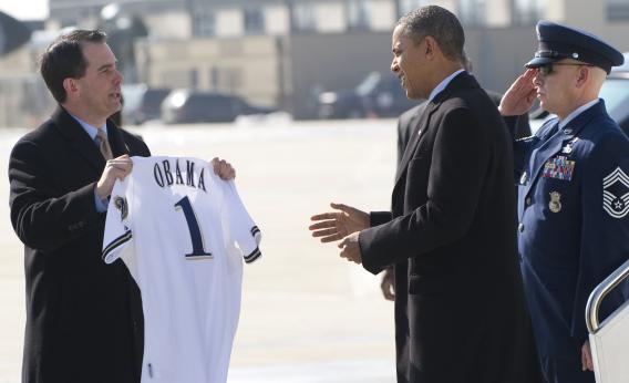 Scott Walker hands Obama a Brewers jersey.