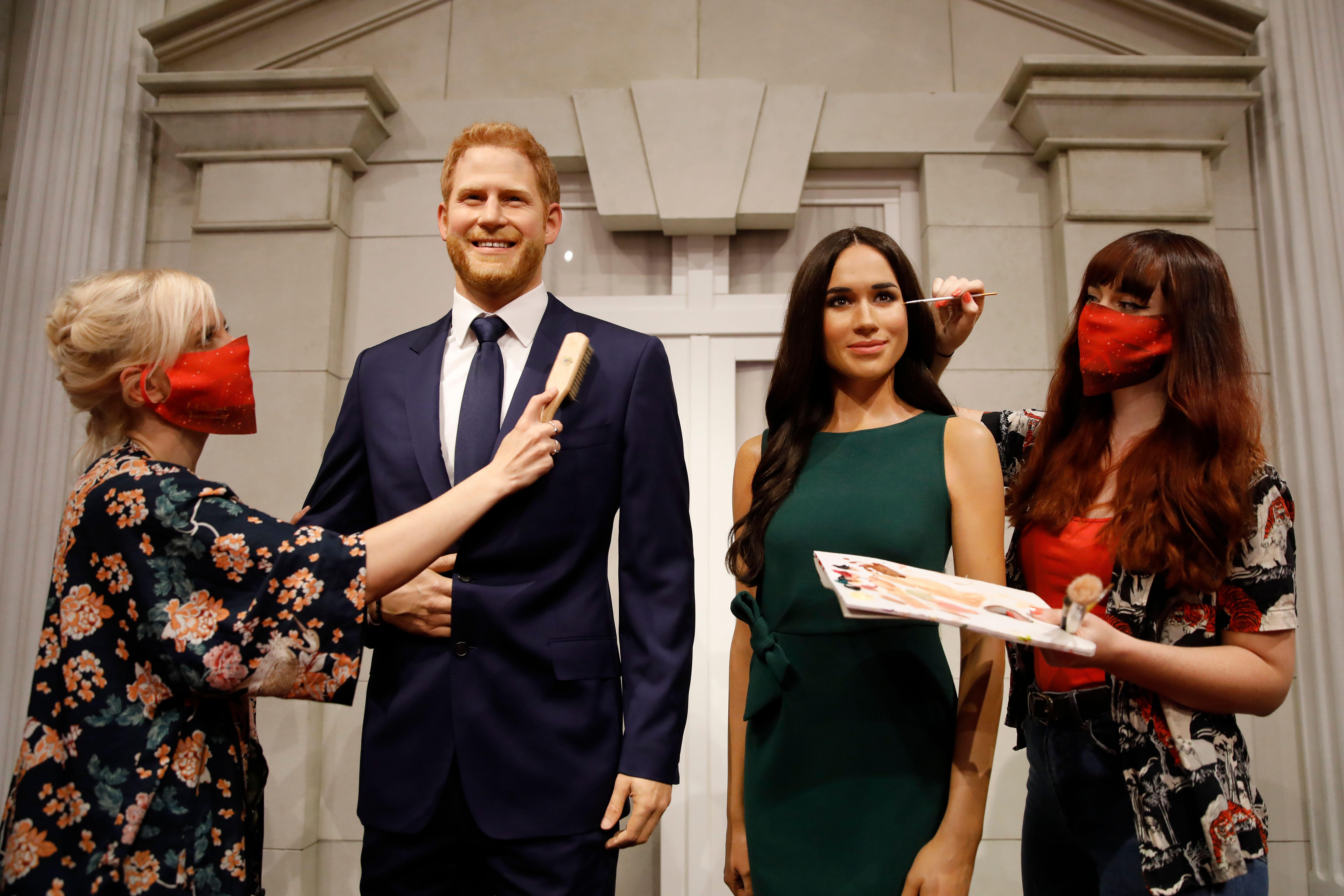 Artists put the finishing touches to wax figures of Britain's Prince Harry, Duke of Sussex and Britain's Meghan, Duchess of Sussex as Madame Tussauds prepares to reopen its doors to the public on July 30, 2020 following the easing of coronavirus lockdown restrictions in England. (Photo by Tolga AKMEN / AFP) (Photo by TOLGA AKMEN/AFP via Getty Images)