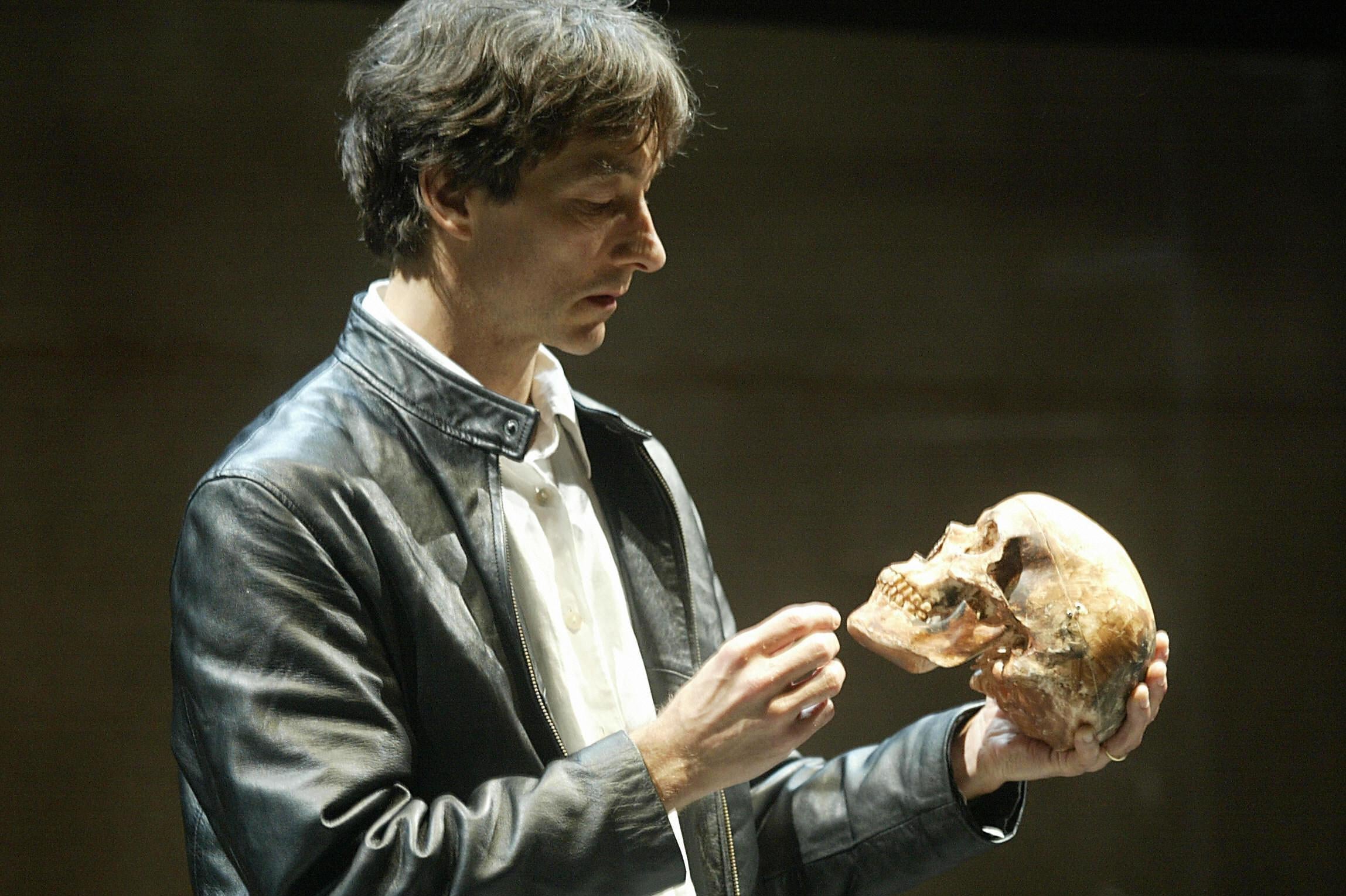 Jonathan Douglas holds a skull as he portrays a futuristic Hamlet at the Shouson theatre in Hong Kong.