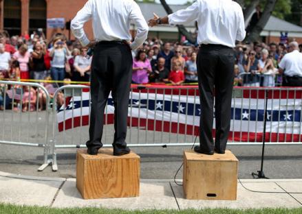 Mitt Romney, right, and Paul Ryan, left, speak to an overflow crowd during a campaign rally at Randolph Macon College in August in Ashland, Virginia. 