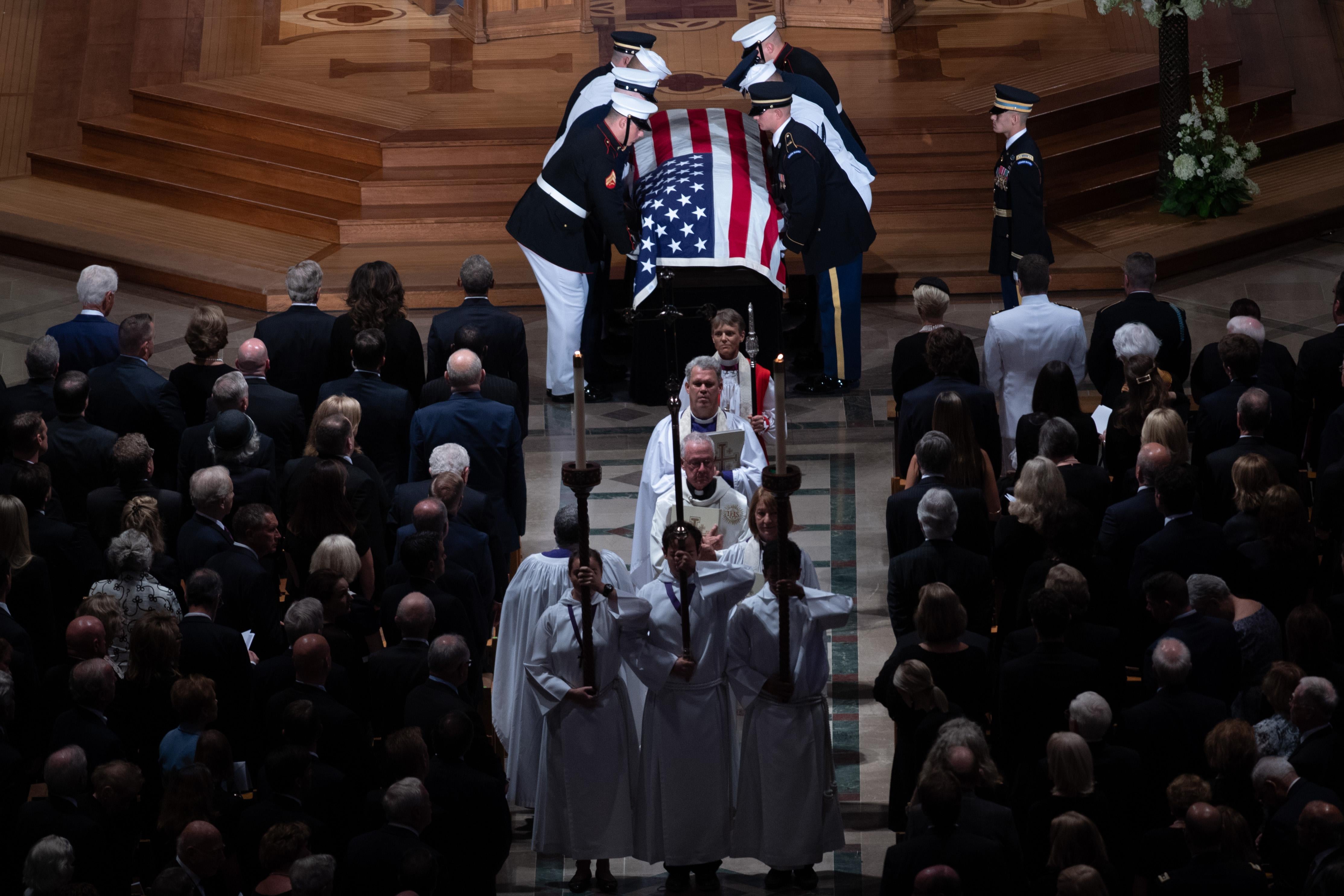The casket of John McCain, carried out by a Military Honor Guard.
